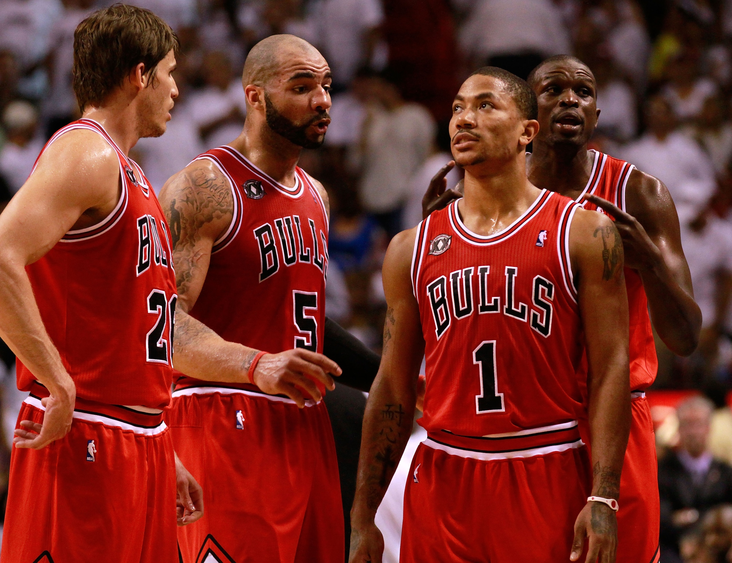 MIAMI, FL - MAY 24: (L-R) Kyle Korver #26, Carlos Boozer #5, Derrick Rose #1 and Luol Deng #9 of the Chicago Bulls look on against the Miami Heat in Game Four of the Eastern Conference Finals during the 2011 NBA Playoffs on May 24, 2011 at American Airlin