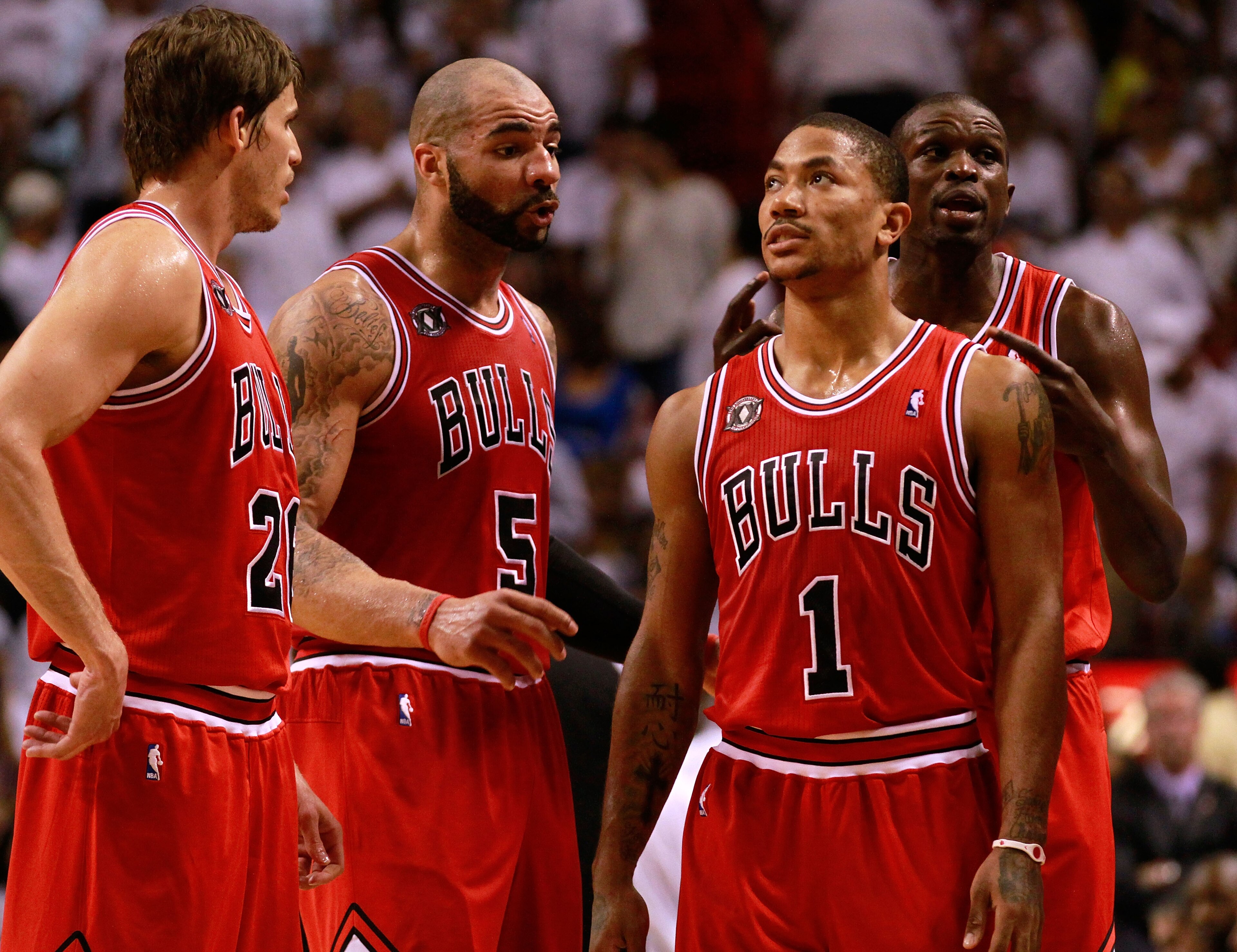 MIAMI, FL - MAY 24: (L-R) Kyle Korver #26, Carlos Boozer #5, Derrick Rose #1 and Luol Deng #9 of the Chicago Bulls look on against the Miami Heat in Game Four of the Eastern Conference Finals during the 2011 NBA Playoffs on May 24, 2011 at American Airlin