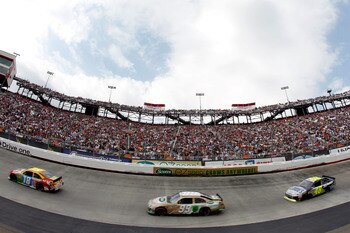 BRISTOL, TN - MARCH 20:  Kyle Busch, driver of the #18 M&M's Toyota, leads Carl Edwards, driver of the #99 Scotts EZ Seed Ford, and Jimmie Johnson, driver of the #48 Lowe's/Kobalt Tools Chevrolet, during the NASCAR Sprint Cup Series Jeff Byrd 500 Presente