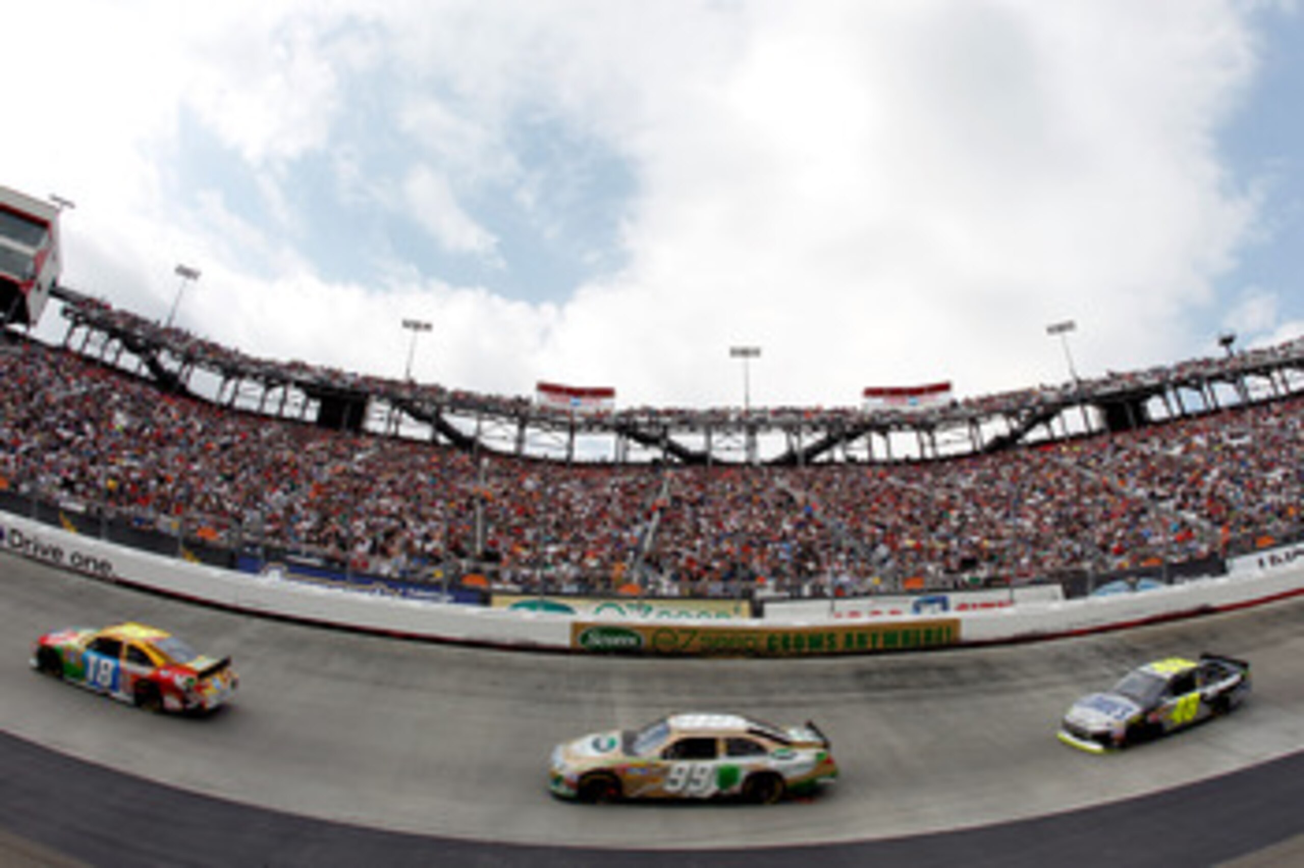 BRISTOL, TN - MARCH 20:  Kyle Busch, driver of the #18 M&M's Toyota, leads Carl Edwards, driver of the #99 Scotts EZ Seed Ford, and Jimmie Johnson, driver of the #48 Lowe's/Kobalt Tools Chevrolet, during the NASCAR Sprint Cup Series Jeff Byrd 500 Presente