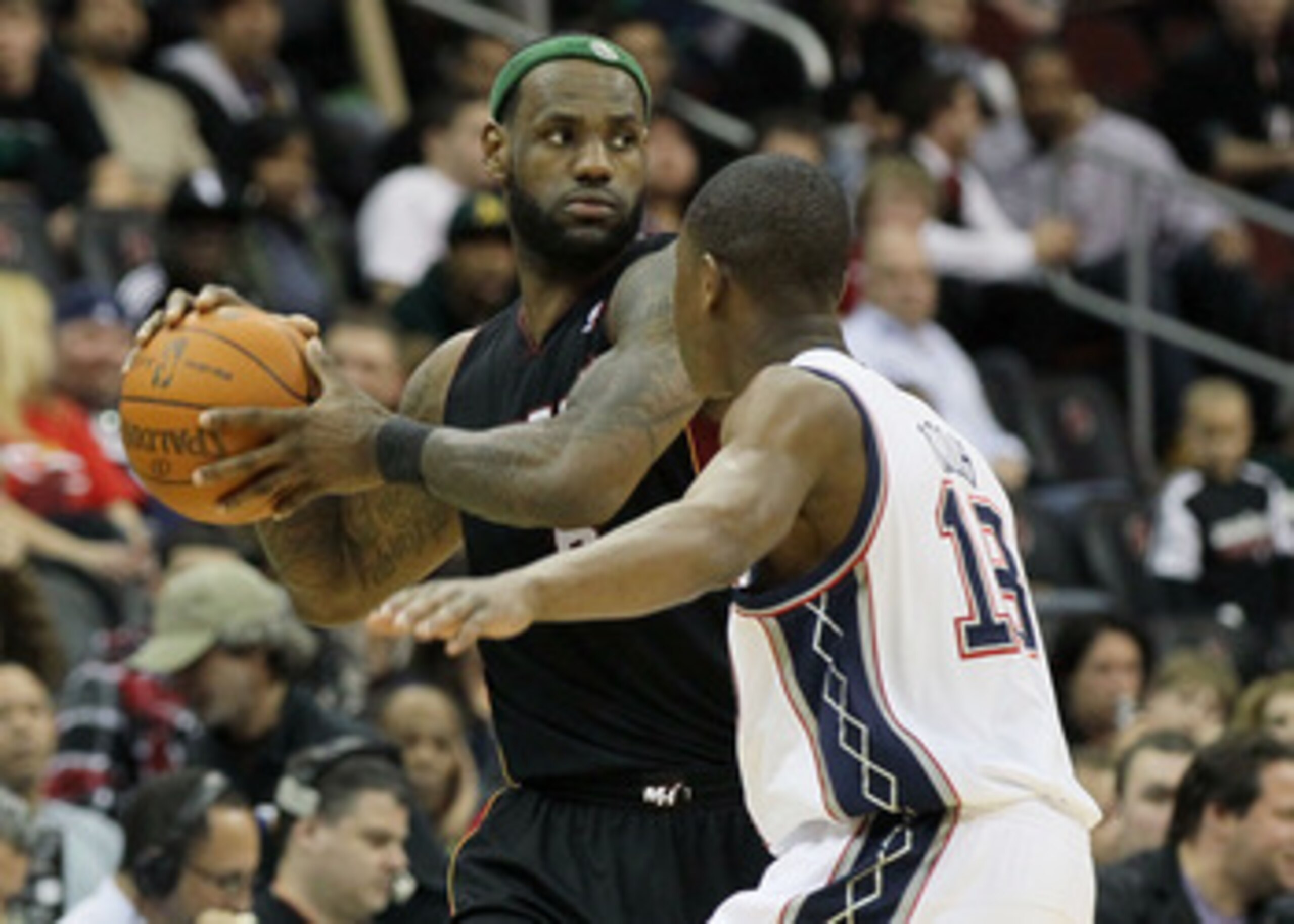 NEWARK, NJ - APRIL 03: LeBron James #6 of the Miami Heat controls the ball against Ben Uzoh #18 of the New Jersey Nets at the Prudential Center on April 3, 2011 in Newark, New Jersey.The Heat defeated the Nets 108-94.NOTE TO USER: User expressly acknowled