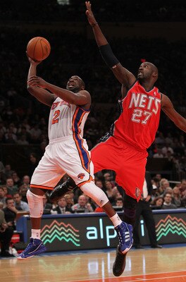 NEW YORK, NY - NOVEMBER 30:  Raymond Felton #2 of the New York Knicks shoots the ball under the block of Johan Petro #27 of the New Jersey Nets on November 30, 2010 at Madison Square Garden in New York City. NOTE TO USER: User expressly acknowledges and a