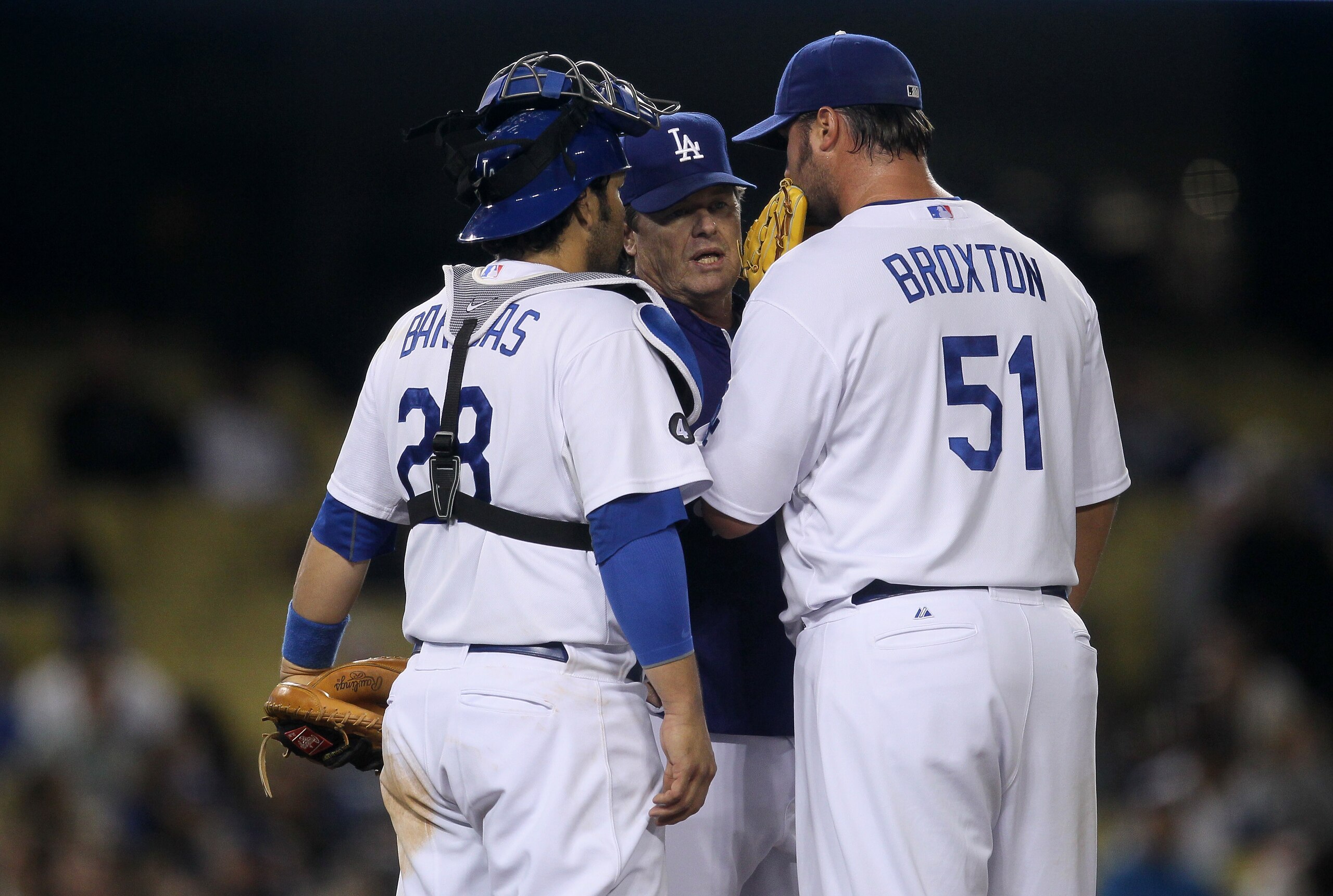 LOS ANGELES - APRIL 18:  Pitching coach Rick Honeycutt (C) of the Los Angeles Dodgers meets with pitcher Jonathan Broxton #51 and catcher Rod Barajas #28 during a ninth inning rally by the Atlanta Braves on April 18, 2011 at Dodger Stadium in Los Angeles,
