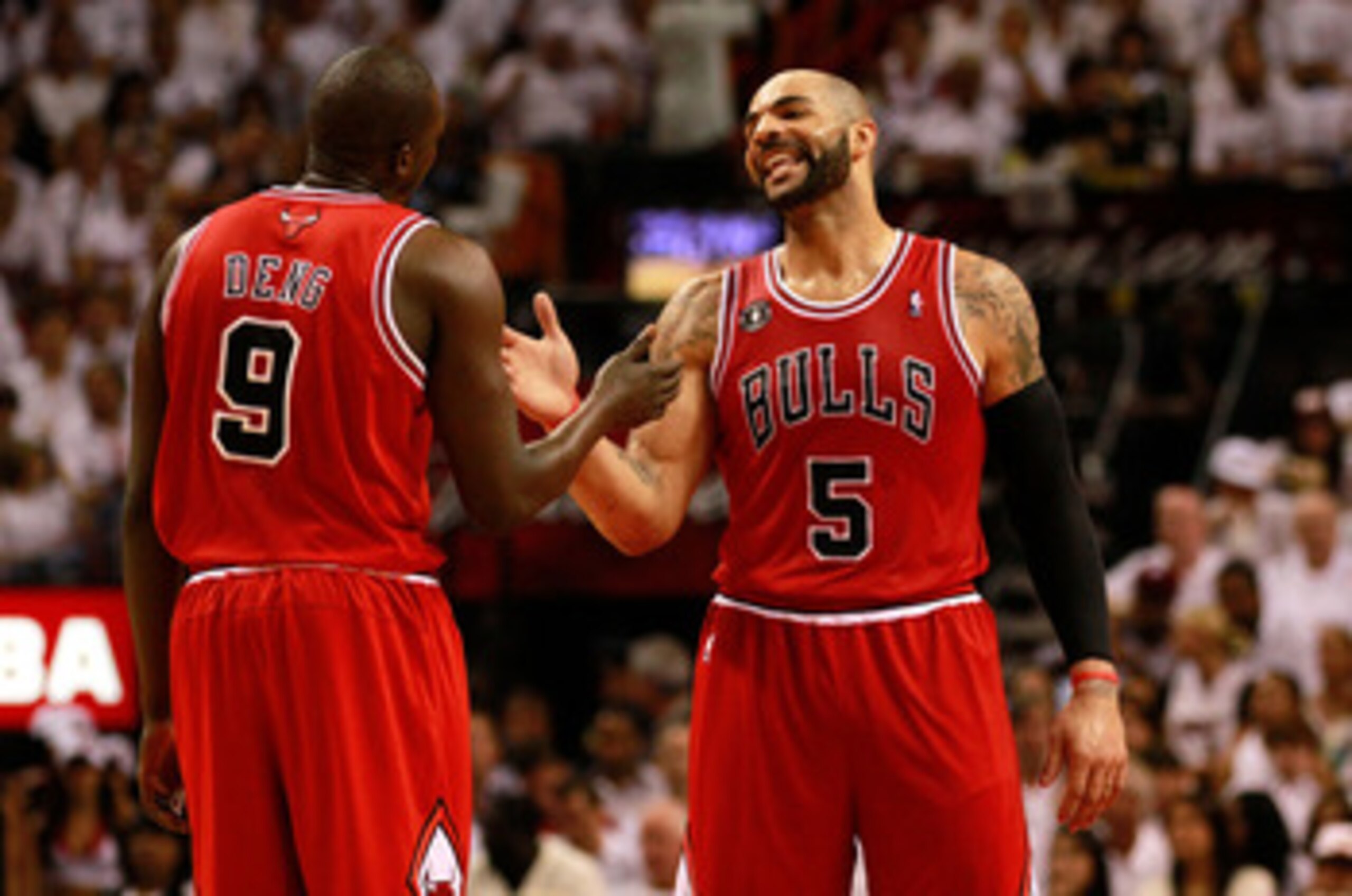MIAMI, FL - MAY 24:  Carlos Boozer #5 (R) and Luol Deng #9 of the Chicago Bulls celebrate a play against the Miami Heat in Game Four of the Eastern Conference Finals during the 2011 NBA Playoffs on May 24, 2011 at American Airlines Arena in Miami, Florida