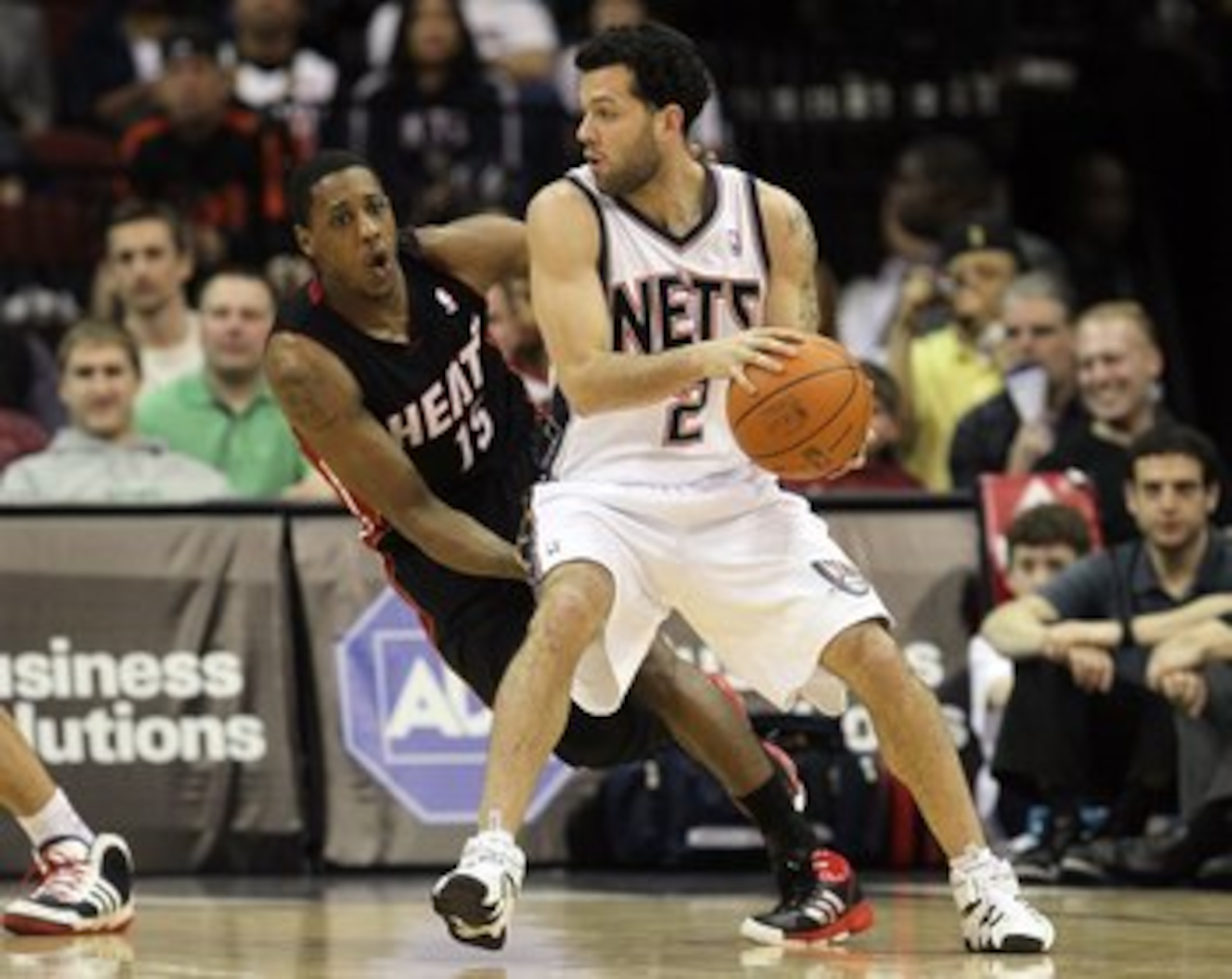 NEWARK, NJ - APRIL 03:  Mario Chalmers #15 of the Miami Heat defends against Jordan Farmar #2 of the New Jersey Nets at the Prudential Center on April 3, 2011 in Newark, New Jersey.NOTE TO USER: User expressly acknowledges and agrees that, by downloading 