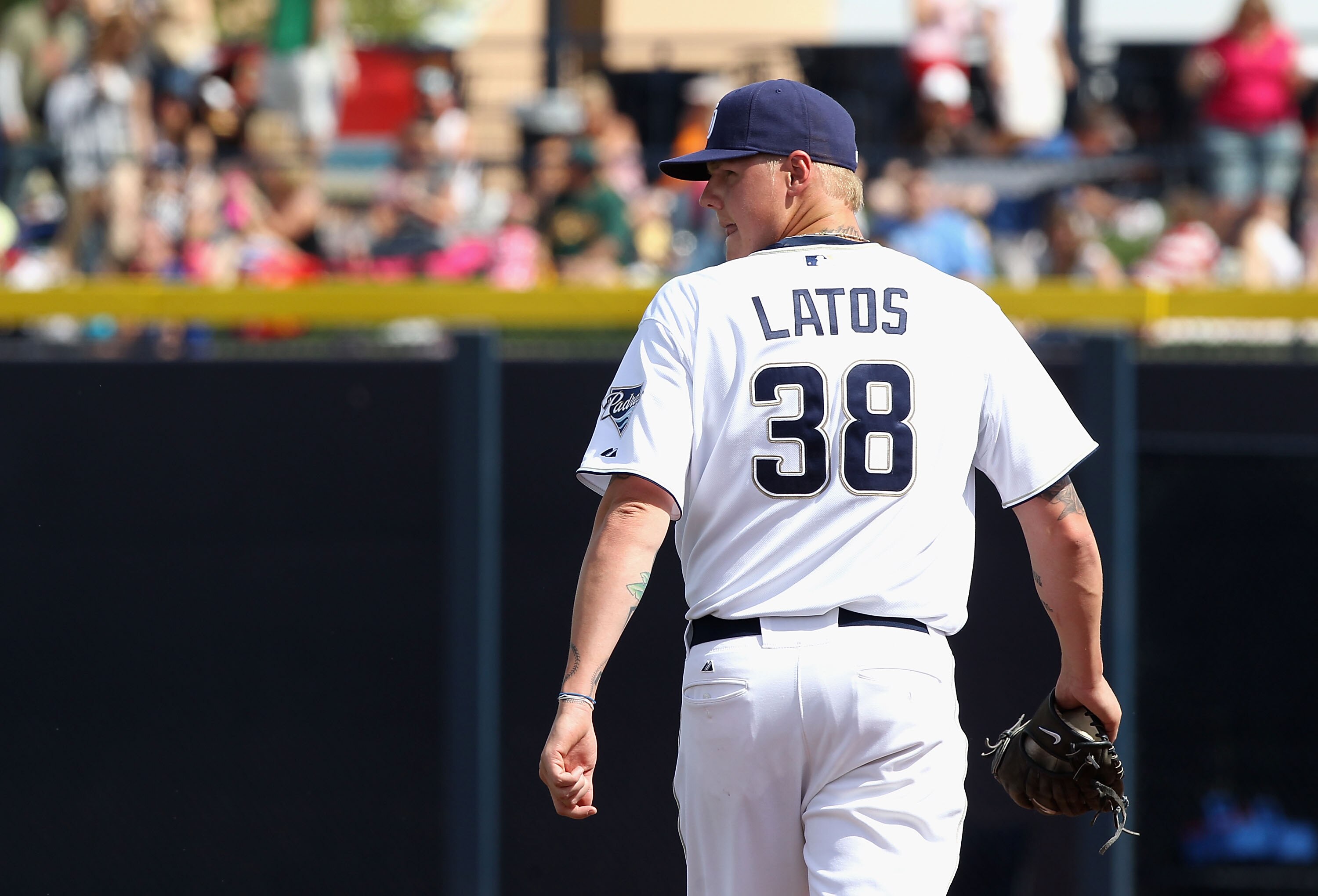 PEORIA, AZ - MARCH 06:  Starting pitcher Mat Latos #38 of the San Diego Padres walks off the field after being removed from the spring training game against the Oakland Athletics at Peoria Stadium on March 6, 2011 in Peoria, Arizona.  (Photo by Christian