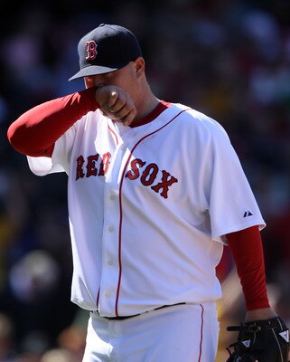 BOSTON, MA - MAY 01: Bobby Jenks #52 of the Boston Red Sox walks off the field after walking in two runs in the sixth inning against the Seattle Mariners on May 1, 2011 at Fenway Park in Boston, Massachusetts.  (Photo by Elsa/Getty Images)