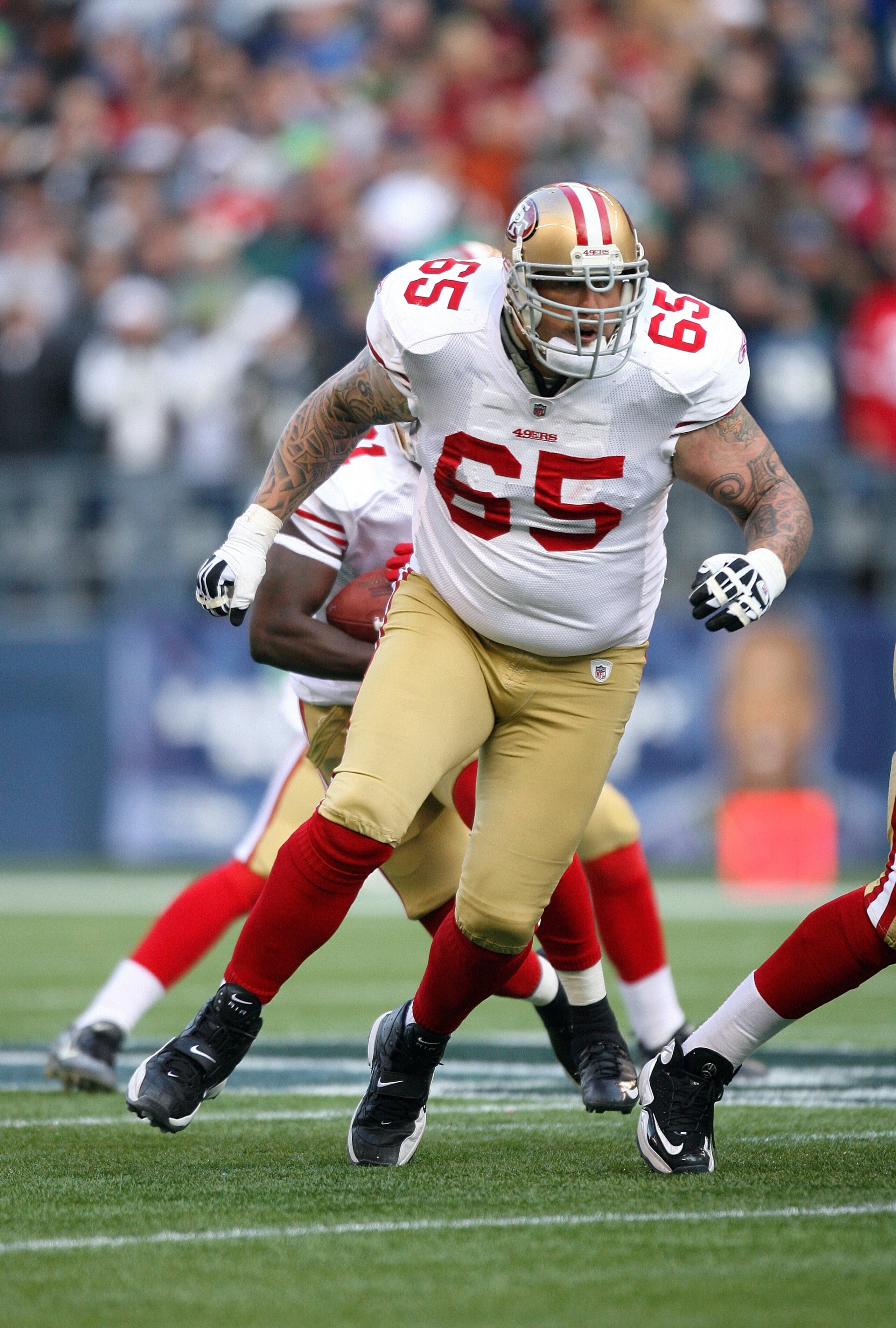 SEATTLE - DECEMBER 6:  Barry Sims #65 of the San Francisco 49ers looks to block on the running play during their NFL game against the Seattle Seahawks on December 6, 2009 at Qwest Field in Seattle, Washington. The Seahawks defeated the 49ers 20-17. (Photo