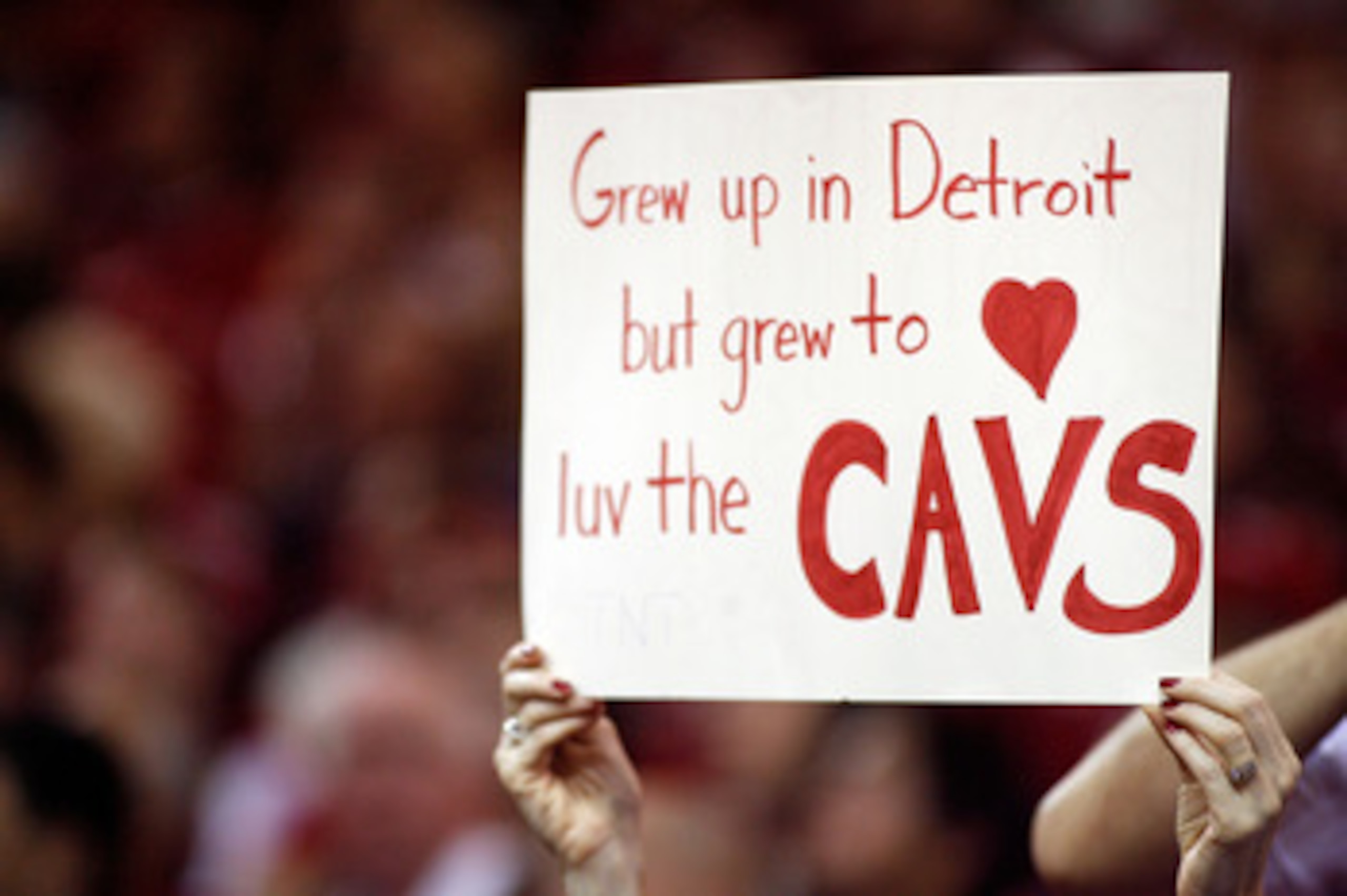 CLEVELAND - MAY 27:  A fan of the Cleveland Cavaliers holds up a sign reading 'Gre up in Detroit but grew to luv the Cavs' against the Detroit Pistons in Game Three of the Eastern Conference Finals during the 2007 NBA Playoffs on May 27, 2007 at the Quick