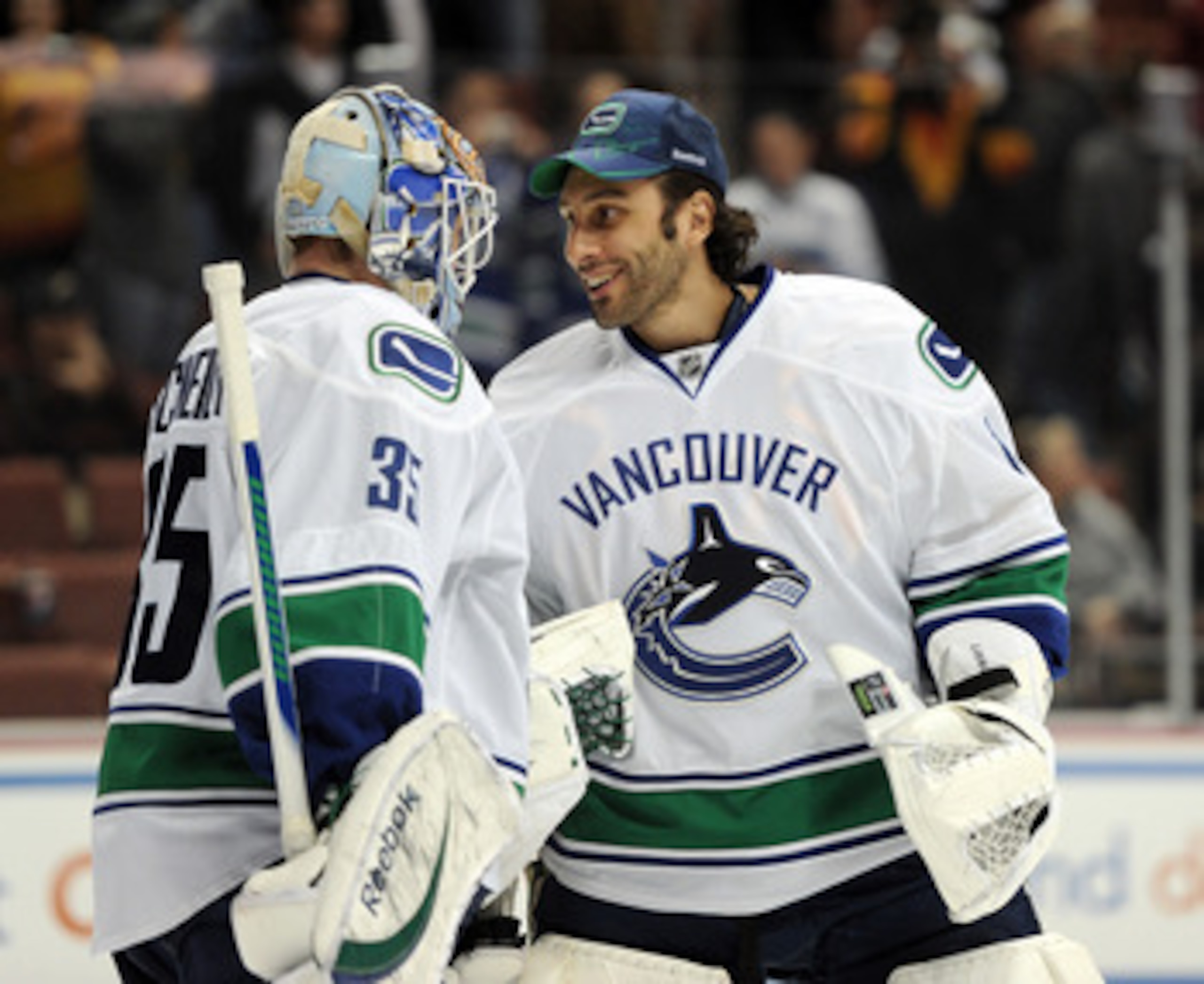 ANAHEIM, CA - MARCH 06:  Cory Schneider #35 of the Vancouver Canucks celebrates his 3-0 shutout of the Anaheim Ducks with goalie Roberto Luongo #1 at the end of the game at the Honda Center on March 6, 2011 in Anaheim, California.  (Photo by Harry How/Get