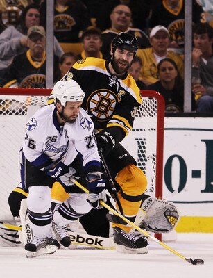 BOSTON, MA - MAY 23:  Martin St. Louis #26 of the Tampa Bay Lightning and Zdeno Chara #33 of the Boston Bruins vie for the puck in Game Five of the Eastern Conference Finals during the 2011 NHL Stanley Cup Playoffs at TD Garden on May 23, 2011 in Boston,