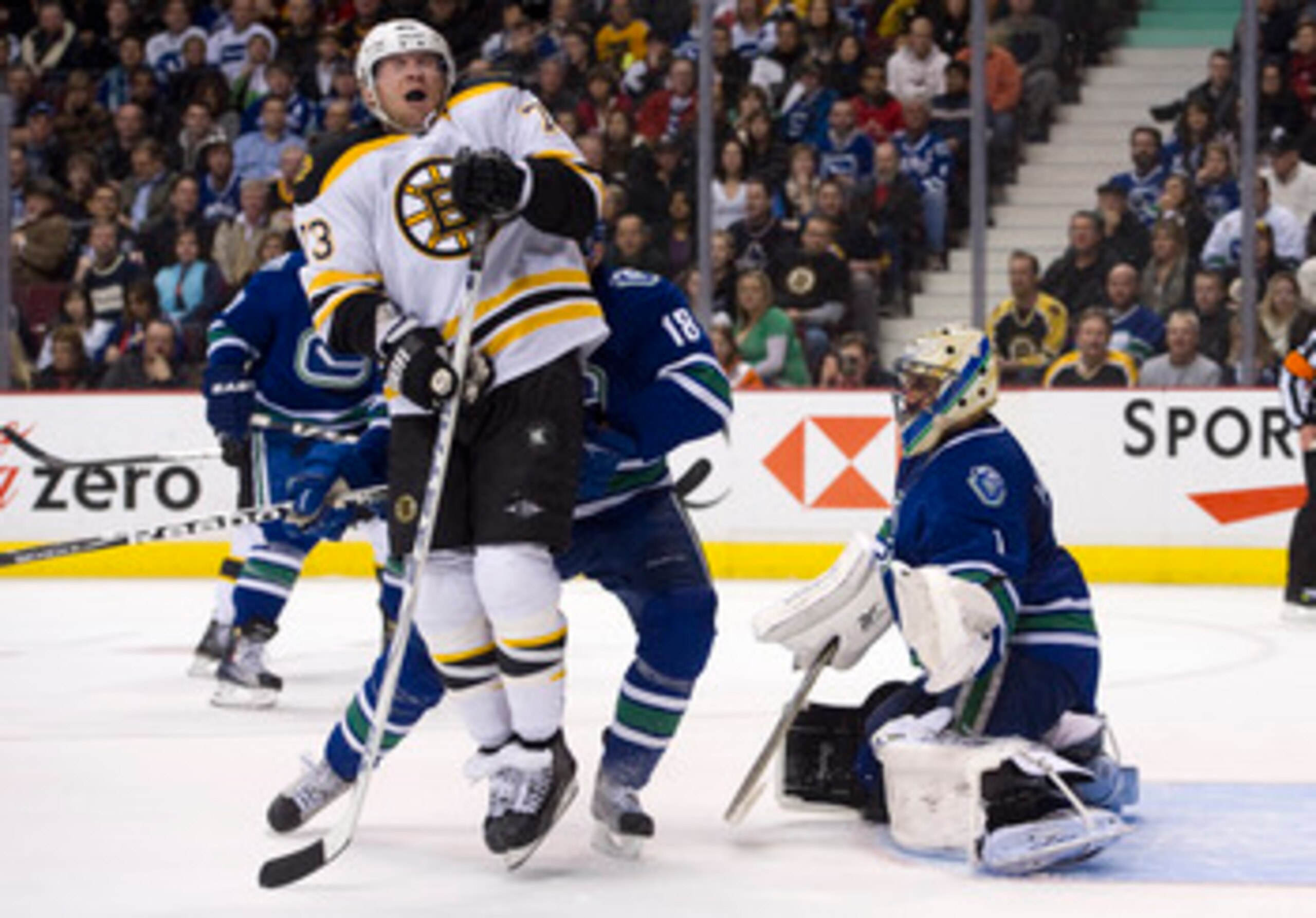 VANCOUVER, CANADA - FEBRUARY 26: Michael Ryder #73 of the Boston Bruins reacts after getting hit with the puck while standing in front of goalie Roberto Luongo #1 during the third period in NHL action on February 26, 2011 at Rogers Arena in Vancouver, Bri
