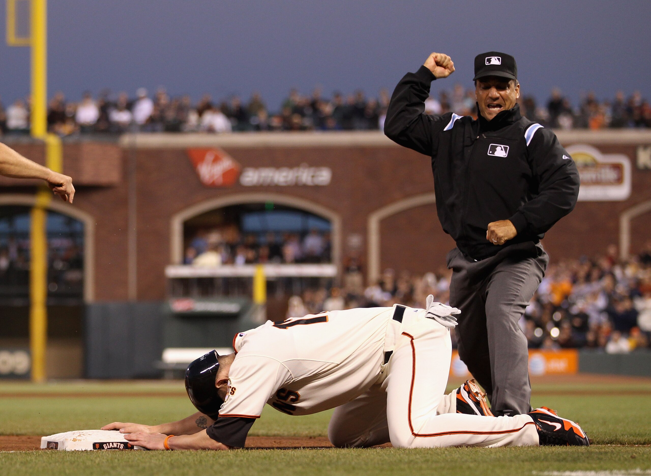 SAN FRANCISCO - JULY 15: Third base umpire Phil Cuzzi calls out Aubrey Huff #17 of the San Francisco Giants after Huff slide past third base and was tagged out by David Wright #5 of the New York Mets in the sixth inning at AT&T Park on July 15, 2010 in S SAN FRANCISCO - JULY 15: Third base umpire Phil Cuzzi calls out Aubrey Huff #17 of the San Francisco Giants after Huff slide past third base and was tagged out by David Wright #5 of the New York Mets in the sixth inning at AT&T Park on July 15, 2010 in S