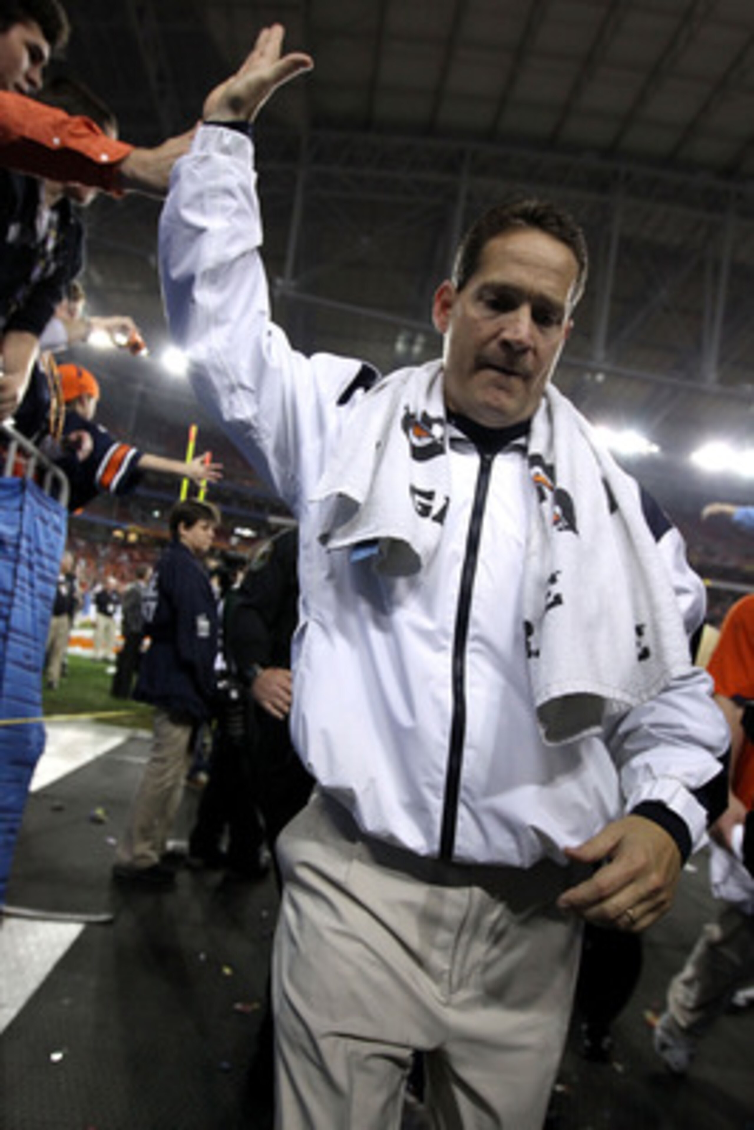 GLENDALE, AZ - JANUARY 10:  Head coach Gene Chizik of the Auburn Tigers celebrates the Tigers 22-19 victory as he holds up the Coaches Trophy after defeating the Oregon Ducks during the Tostitos BCS National Championship Game at University of Phoenix Stad
