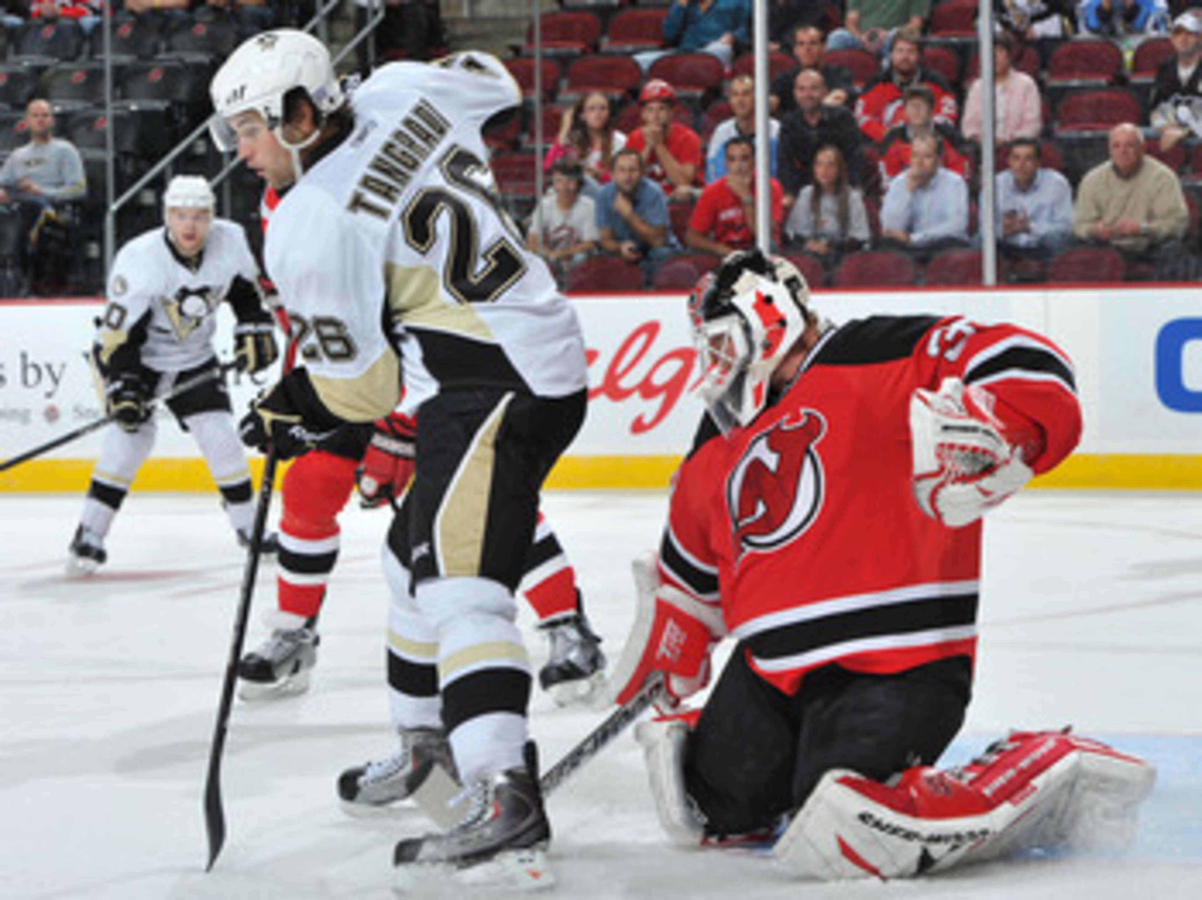 NEWARK, NJ - OCTOBER 11: Martin Brodeur #30 of the New Jersey Devils puts his stick between the legs of Eric Tangradi #26 of the Pittsburgh Penguins as he defends his net during the first period at the Prudential Center on October 11, 2010 in Newark, New NEWARK, NJ - OCTOBER 11: Martin Brodeur #30 of the New Jersey Devils puts his stick between the legs of Eric Tangradi #26 of the Pittsburgh Penguins as he defends his net during the first period at the Prudential Center on October 11, 2010 in Newark, New