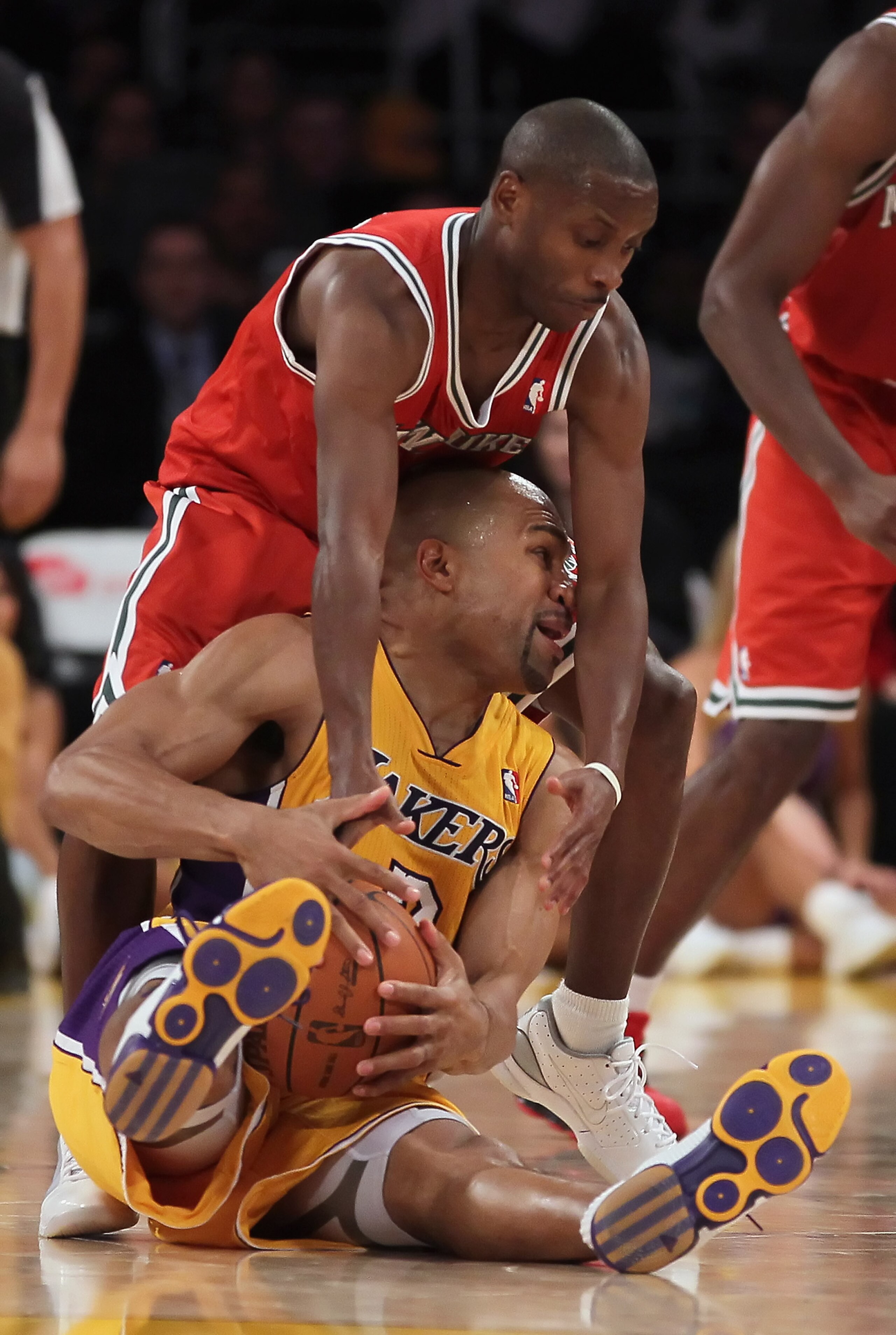 LOS ANGELES, CA - DECEMBER 21:  Earl Boykins #11 of the Milwaukee Bucks ties up Derek Fisher #2 of the Los Angeles Lakers during the second half at Staples Center on December 21, 2010 in Los Angeles, California. The Bucks defeated the Lakers 98-79. NOTE T