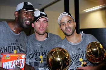 CLEVELAND - JUNE 14:  Tony Parker #9 and Head Coach Gregg Popovich of the San Antonio Spurs celebrates after the win in Game Four of the NBA Finals on June 14, 2007 at the Quicken Loans Arena in Cleveland, Ohio. NOTE TO USER: User expressly acknowledges a