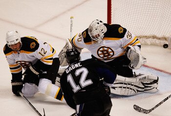 TAMPA, FL - MAY 21:  Simon Gagne #12 of the Tampa Bay Lightning scores a third period goal past Tomas Kaberle #12 and Tim Thomas #30 of the Boston Bruins in Game Four of the Eastern Conference Finals during the 2011 NHL Stanley Cup Playoffs at St Pete Tim