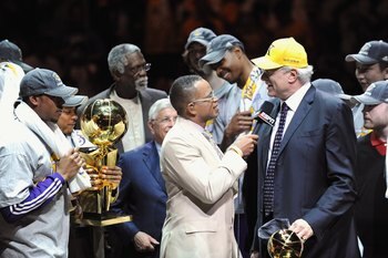 ORLANDO, FL - JUNE 14:  Kobe Bryant #24 of the Los Angeles Lakers holds the Bill Russell MVP trophy and the Larry O'Brien trophy after defeating the Orlando Magic in Game Five of the 2009 NBA Finals on June 14, 2009 at Amway Arena in Orlando, Florida. The