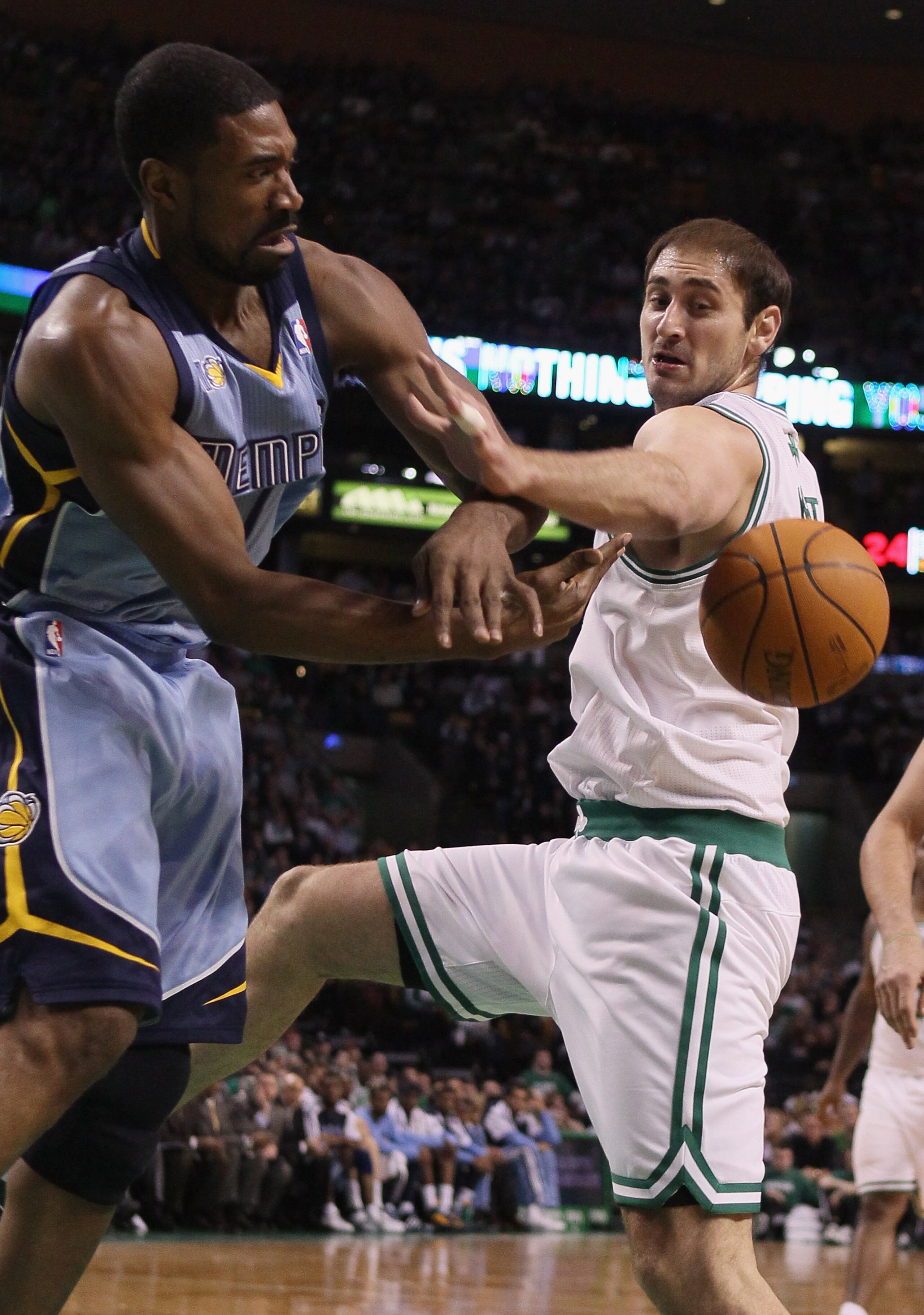 BOSTON, MA - MARCH 23:  Leon Powe #7 of the Memphis Grizzlies and Nenad Krstic #4 of the Boston Celtics fight for the ball on March 23, 2011 at the TD Garden in Boston, Massachusetts.  The Memphis Grizzlies defeated the Boston Celtics 90-87. NOTE TO USER:
