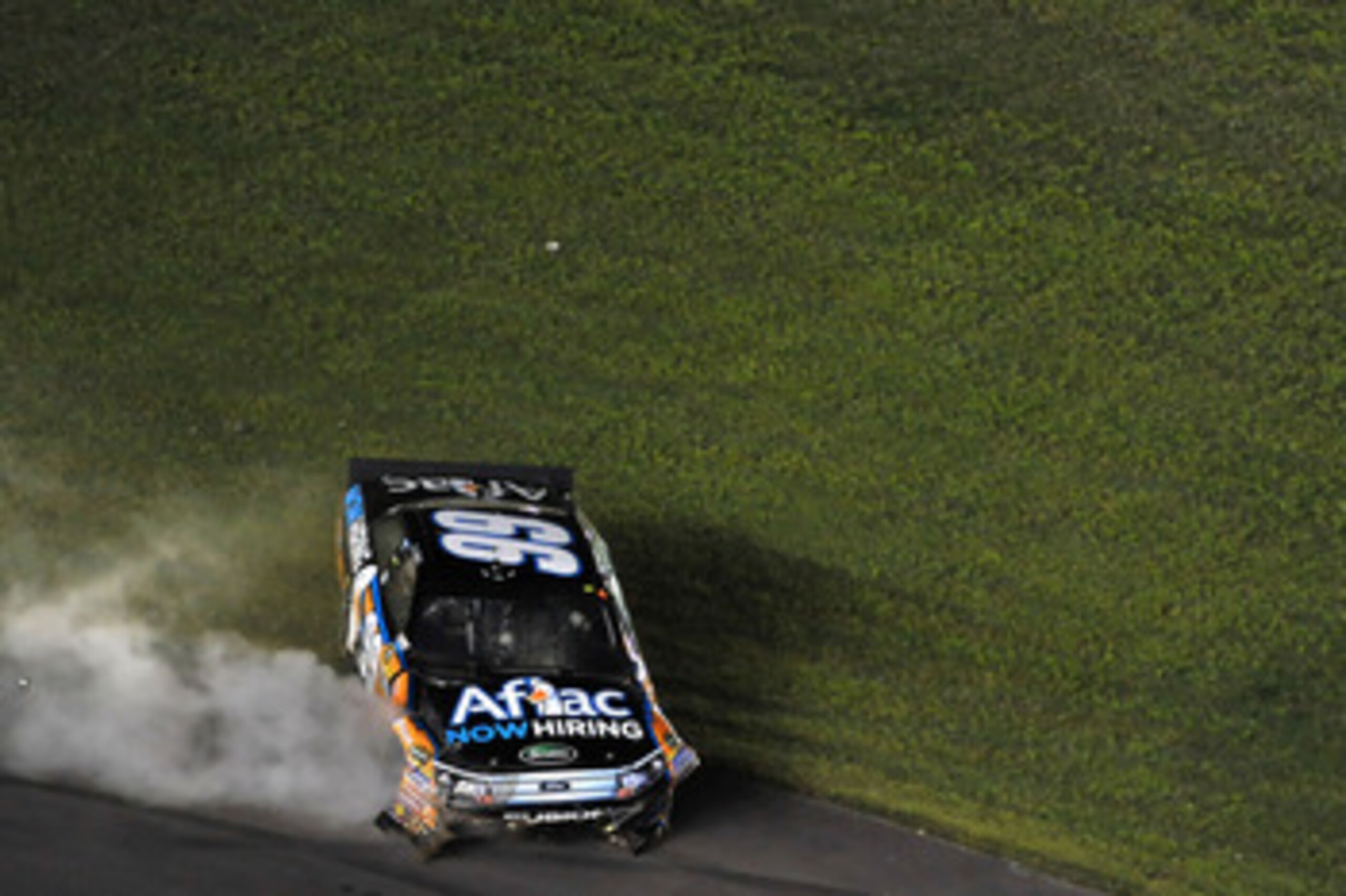CHARLOTTE, NC - MAY 21: Carl Edwards, driver of the #99 Aflac Ford, crashes his car while celebrating, after winning the NASCAR Sprint All-Star Race at Charlotte Motor Speedway on May 21, 2011 in Charlotte, North Carolina.  (Photo by Drew Hallowell/Getty 