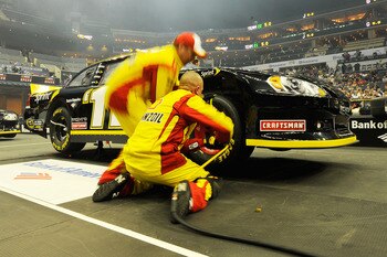 CHARLOTTE, NC - MAY 19:  Crew members for the #22 Shell/Pennzoil Dodge change a tire during the NASCAR Sprint Pit Crew Challenge at Time Warner Cable Arena on May 19, 2011 in Charlotte, North Carolina.  (Photo by Jared C. Tilton/Getty Images for NASCAR)