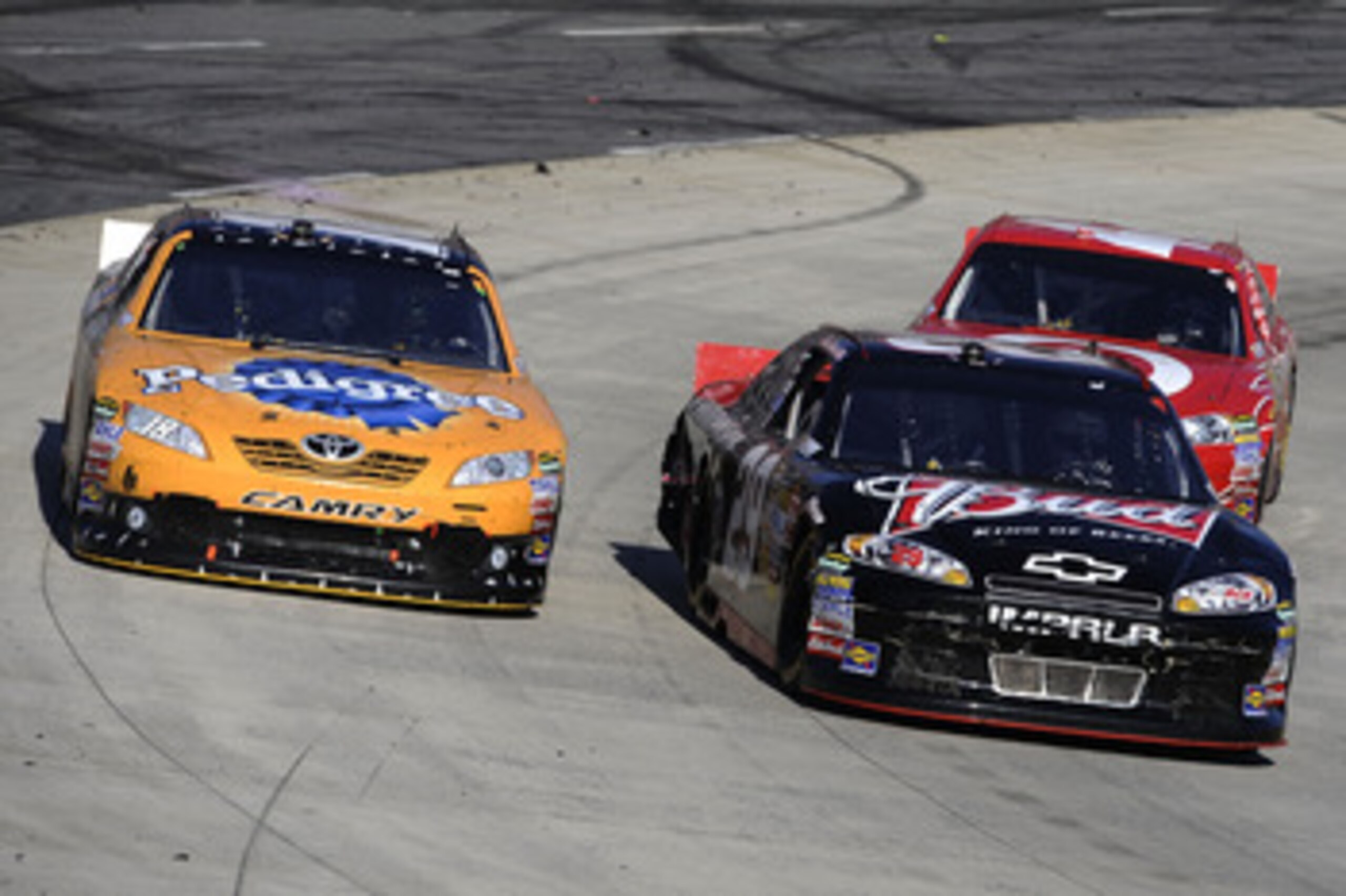 MARTINSVILLE, VA - APRIL 03:  Kevin Harvick, driver of the #29 Budweiser Chevrolet, leads Kyle Busch, driver of the #18 Pedigree Toyota, and and Juan Pablo Montoya, driver of the #42 Target Chevrolet, during the NASCAR Sprint Cup Series Goody's Fast Relie