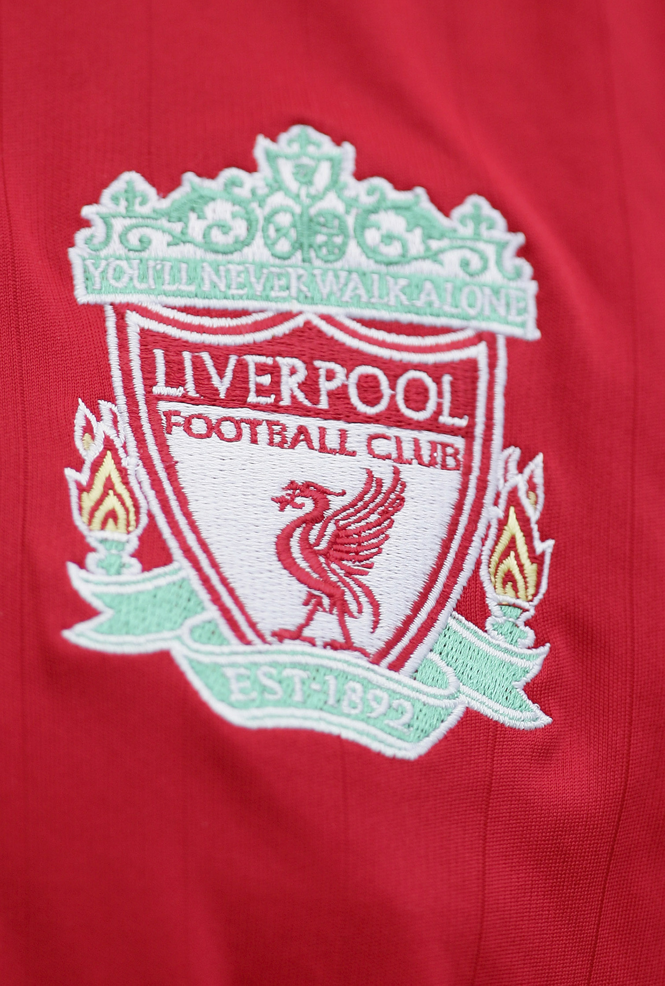 LIVERPOOL, UNITED KINGDOM - SEPTEMBER 23: The Liverpool badge on a fans shirt during the Barclays Premiership match between Liverpool and Tottenham Hotspur at Anfield on September 23, 2006 in Liverpool, England. (Photo by Laurence Griffiths/Getty Images) LIVERPOOL, UNITED KINGDOM - SEPTEMBER 23: The Liverpool badge on a fans shirt during the Barclays Premiership match between Liverpool and Tottenham Hotspur at Anfield on September 23, 2006 in Liverpool, England. (Photo by Laurence Griffiths/Getty Images)