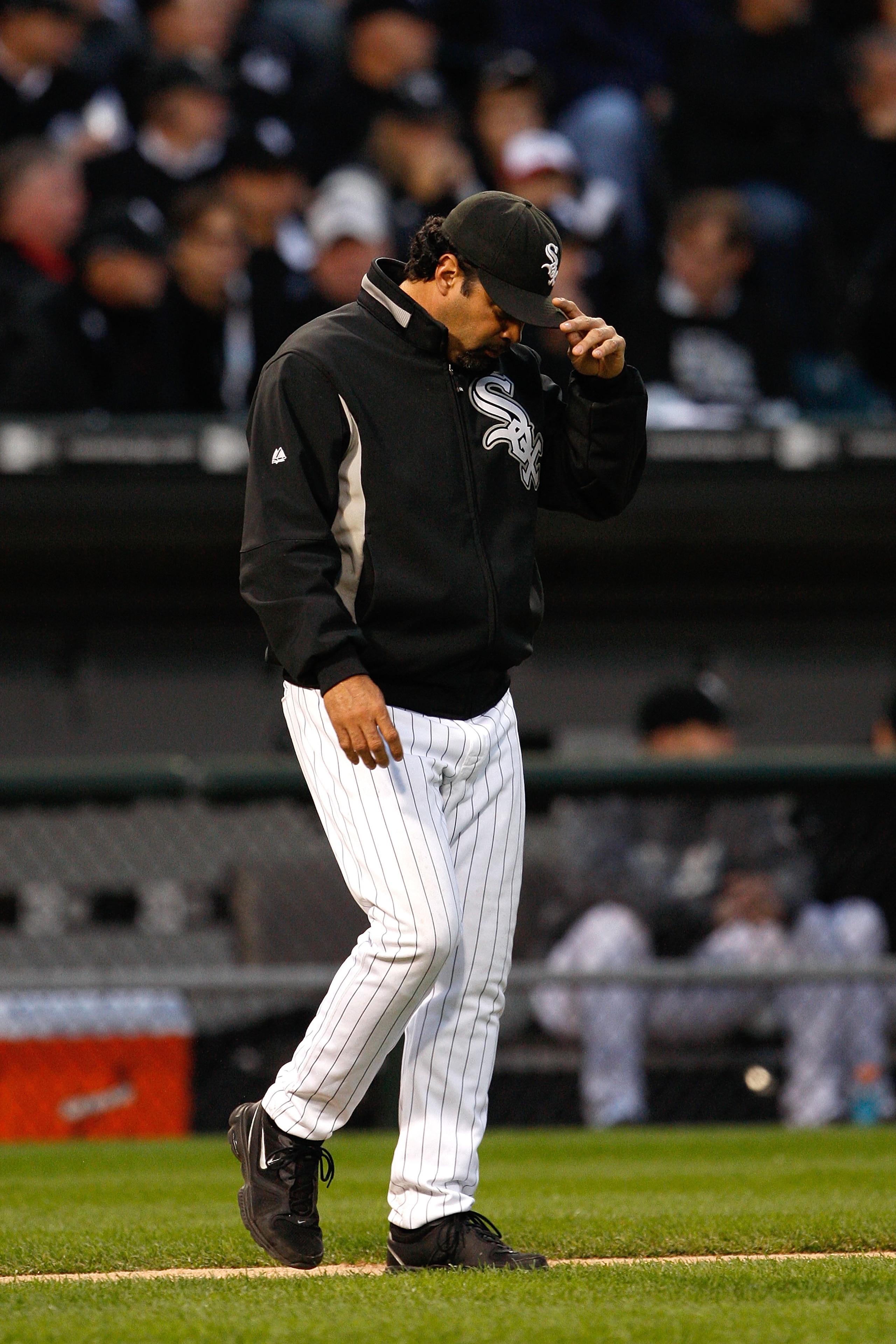 CHICAGO - OCTOBER 06: Manager Ozzie Guillen #13 of the Chicago White Sox walks out to the mound with his head down against the Tampa Bay Rays in Game Four of the ALDS during the 2008 MLB Playoffs at U.S. Cellular Field on October 6, 2008 in Chicago, Illi CHICAGO - OCTOBER 06: Manager Ozzie Guillen #13 of the Chicago White Sox walks out to the mound with his head down against the Tampa Bay Rays in Game Four of the ALDS during the 2008 MLB Playoffs at U.S. Cellular Field on October 6, 2008 in Chicago, Illi