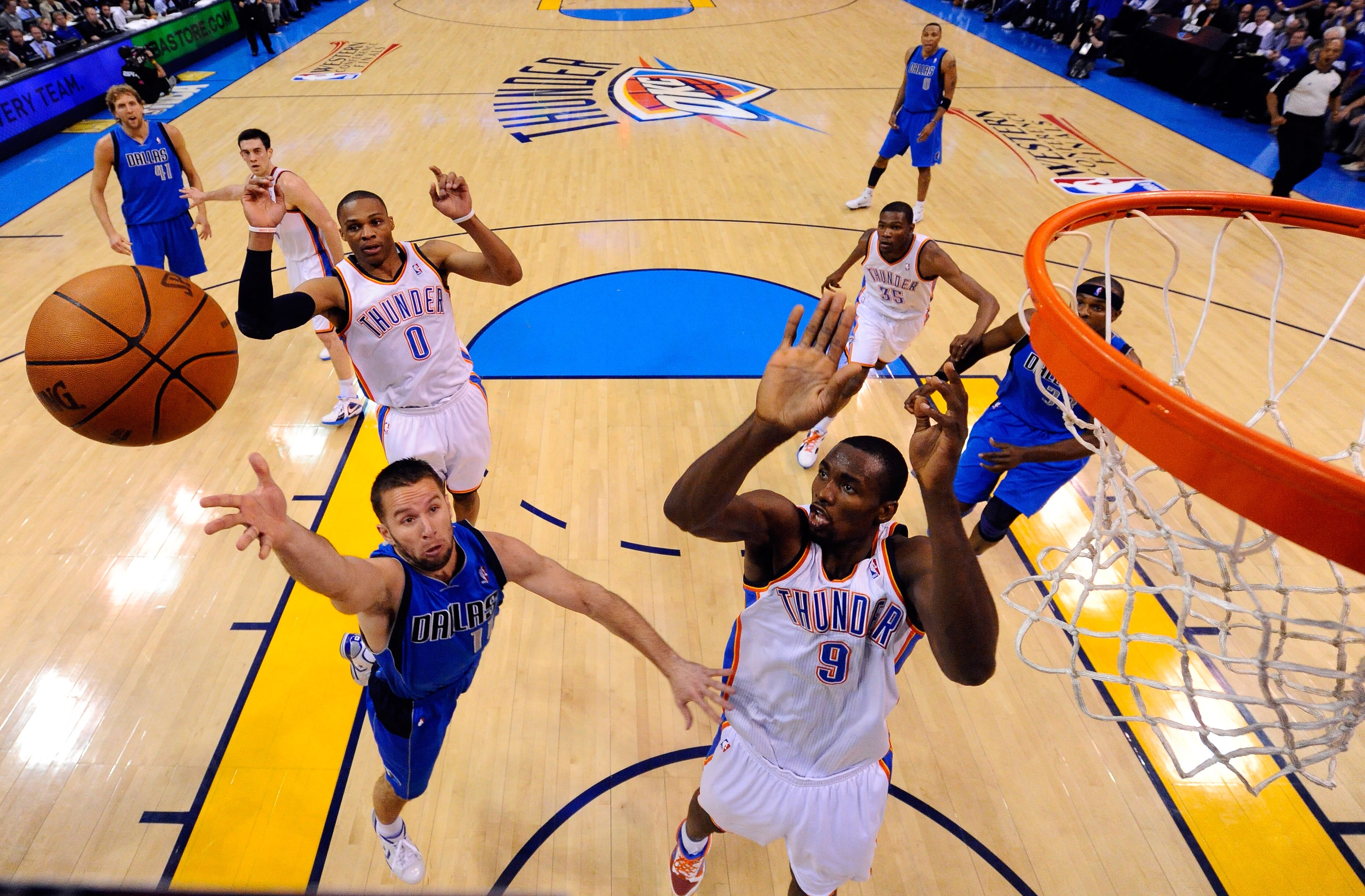OKLAHOMA CITY, OK - MAY 21:  Jose Juan Barea #11 of the Dallas Mavericks goes up for a shot against Serge Ibaka #9 of the Oklahoma City Thunder in the first half in Game Three of the Western Conference Finals during the 2011 NBA Playoffs at Oklahoma City