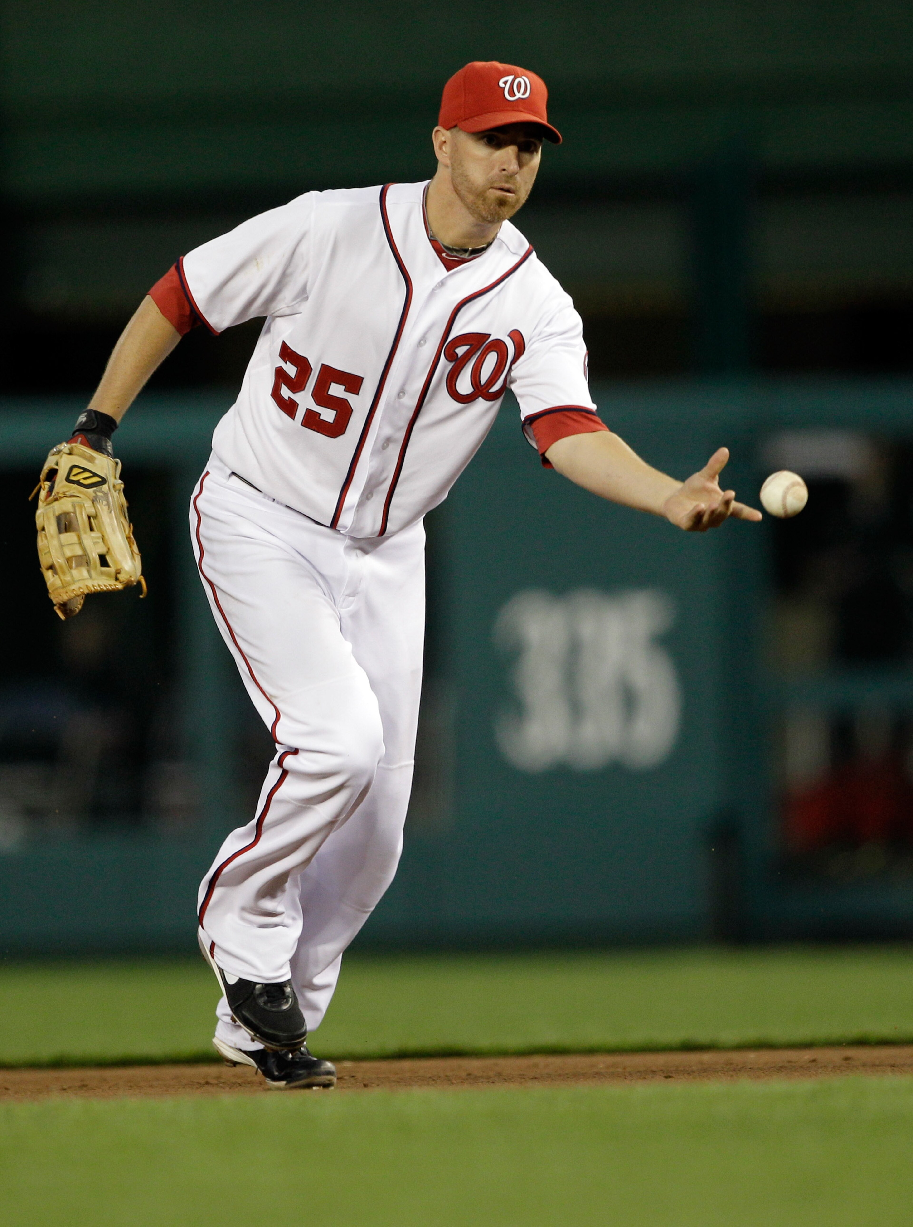 WASHINGTON, DC - APRIL 14: First baseman Adam LaRoche #25 of the Washington Nationals flips the ball to the bag against the Philadelphia Phillies at Nationals Park on April 14, 2011 in Washington, DC.  (Photo by Rob Carr/Getty Images)