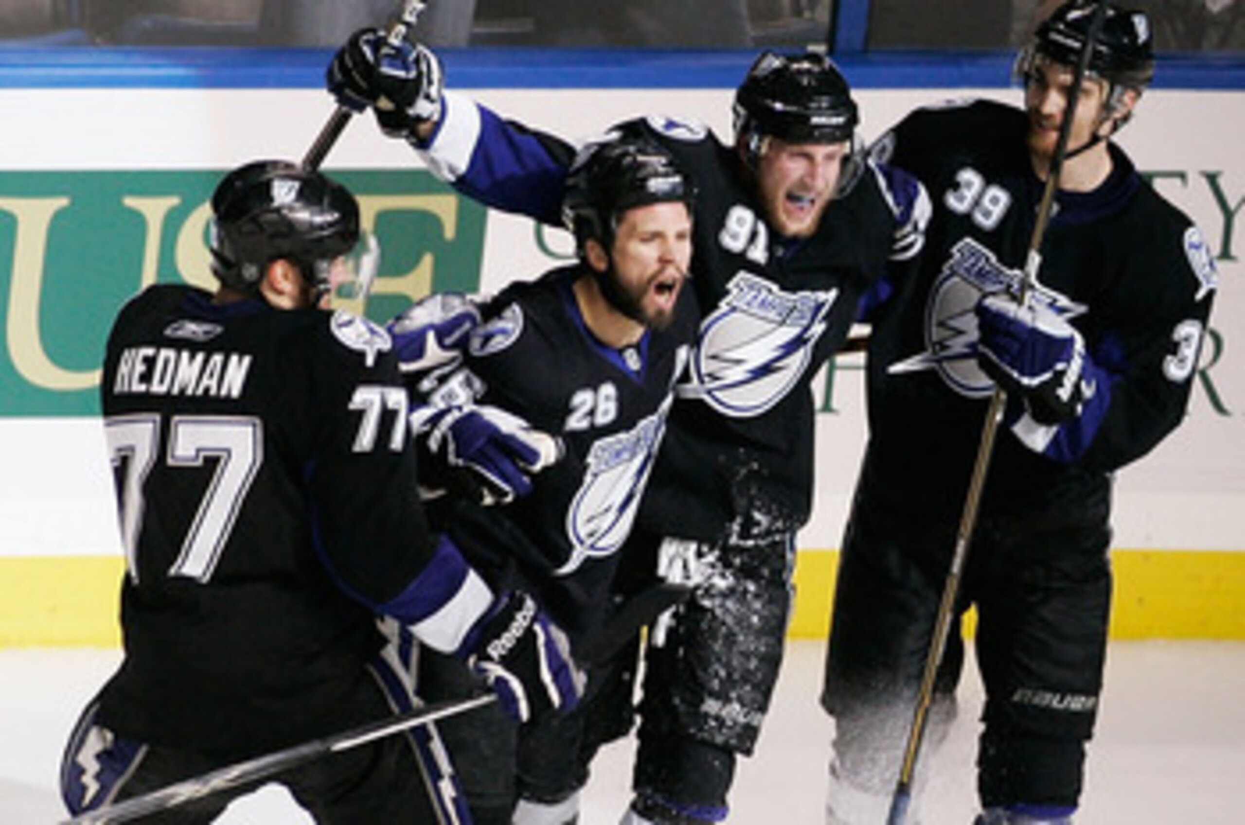 TAMPA, FL - MAY 25: Martin St. Louis #26 of the Tampa Bay Lightning celebrates his second period goal with teammates in Game Six of the Eastern Conference Finals against the Boston Bruins during the 2011 NHL Stanley Cup Playoffs at St Pete Times Forum on TAMPA, FL - MAY 25: Martin St. Louis #26 of the Tampa Bay Lightning celebrates his second period goal with teammates in Game Six of the Eastern Conference Finals against the Boston Bruins during the 2011 NHL Stanley Cup Playoffs at St Pete Times Forum on
