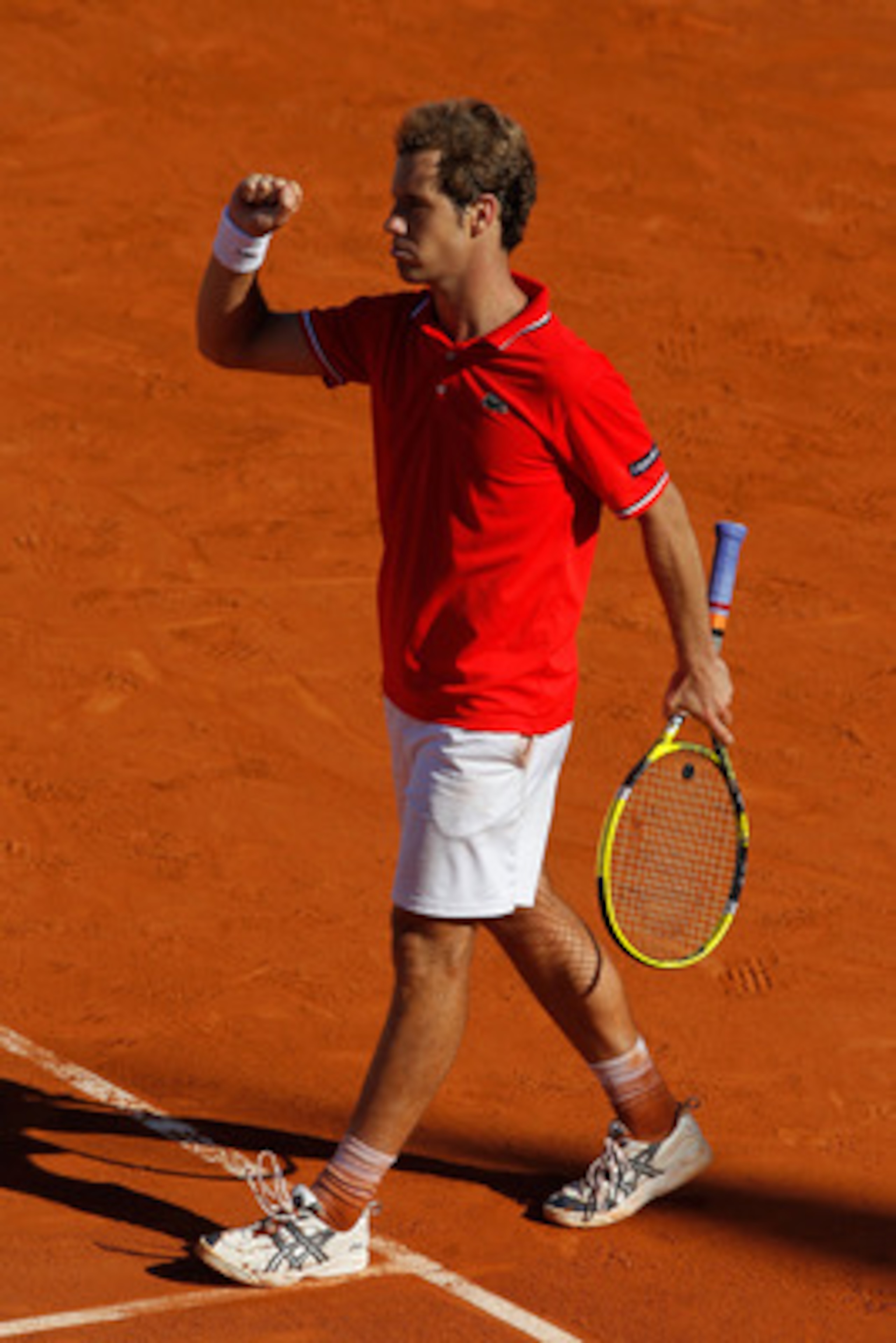 PARIS, FRANCE - MAY 25:  Richard Gasquet of France celebrates match point during the men's singles round two match between Richard Gasquet of France and Marcel Granollers of Spain on day four of the French Open at Roland Garros on May 25, 2011 in Paris, F