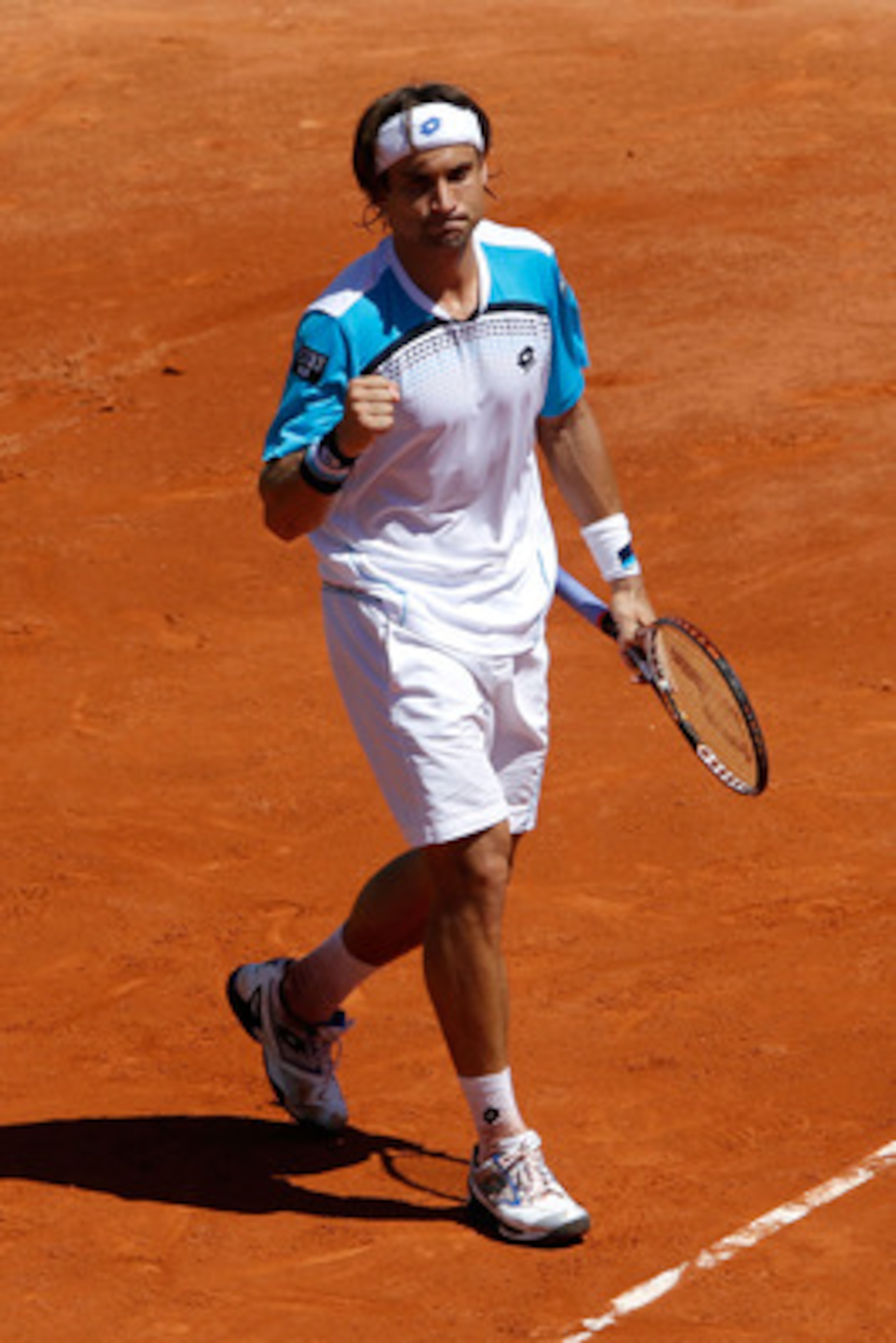 PARIS, FRANCE - MAY 25:  David Ferrer of Spain celebrates match point after the men's singles round two match between David Ferrer of Spain and Julien Benneteau of France on day four of the French Open at Roland Garros on May 25, 2011 in Paris, France.  (