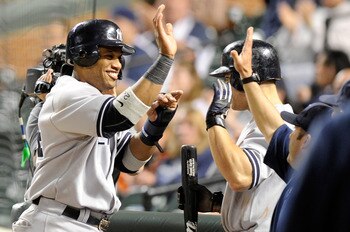 BALTIMORE, MD - MAY 18:  Robinson Cano #24 of the New York Yankees celebrates with teammates after scoring in the fifteenth inning against the Baltimore Orioles at Oriole Park at Camden Yards on May 18, 2011 in Baltimore, Maryland. New York won the game 4