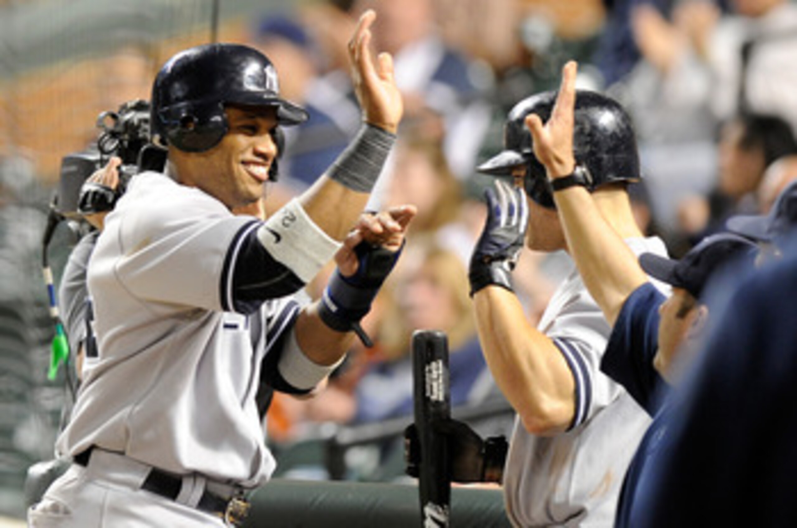 BALTIMORE, MD - MAY 18:  Robinson Cano #24 of the New York Yankees celebrates with teammates after scoring in the fifteenth inning against the Baltimore Orioles at Oriole Park at Camden Yards on May 18, 2011 in Baltimore, Maryland. New York won the game 4