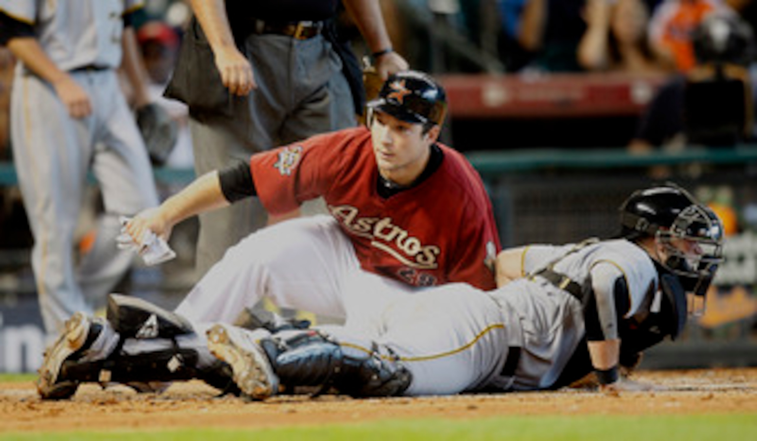 HOUSTON - AUGUST 15:  Brett Wallace #29 of the Houston Astros slides safely into home plate as catcher Chris Snyder #19 of the Pittsburgh Pirates looks around at Minute Maid Park on August 15, 2010 in Houston, Texas.  (Photo by Bob Levey/Getty Images)