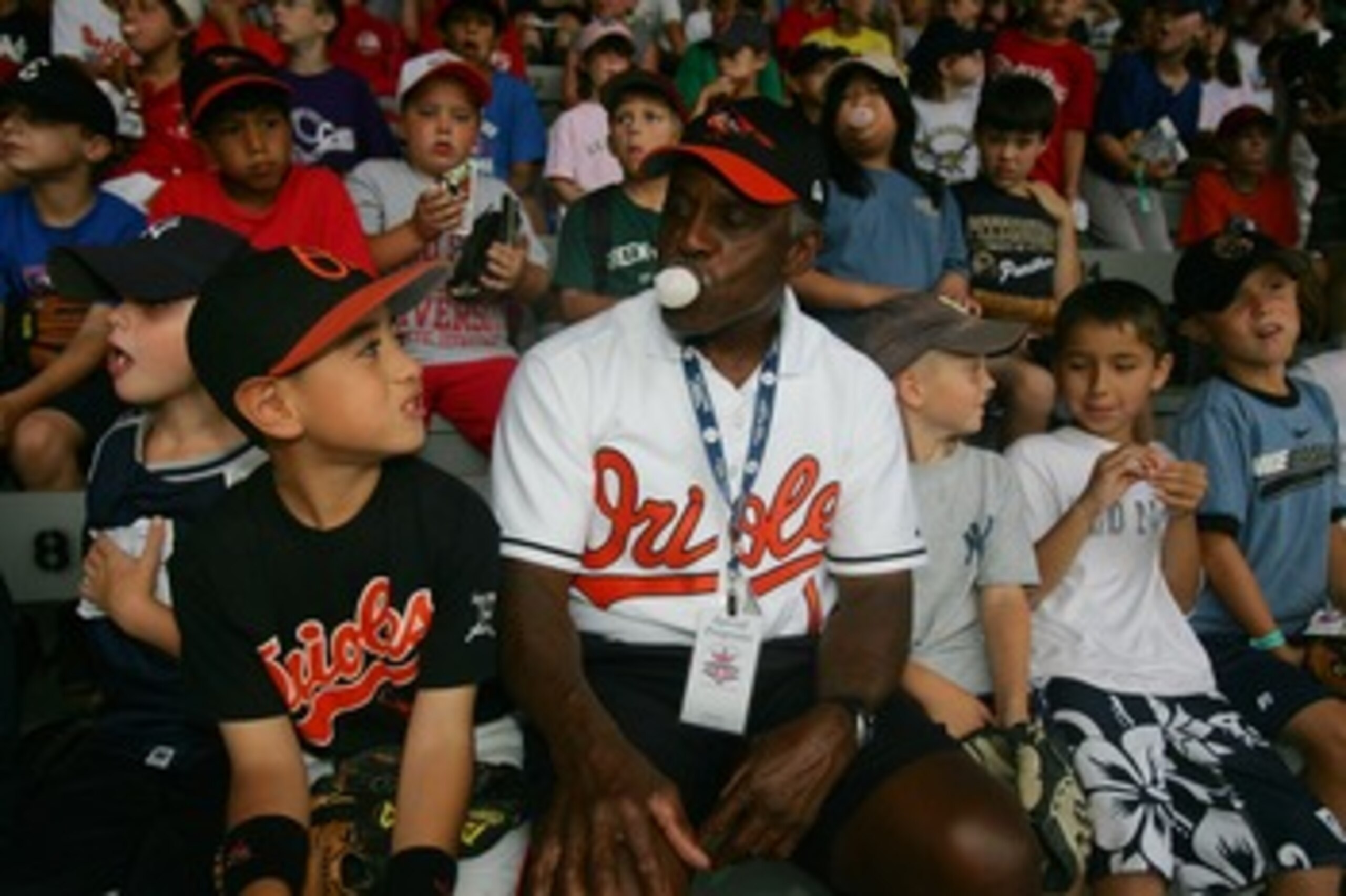 COOPERSTOWN, NY - JULY 27: Baseball legend Al Bumbry blows a bubble nwith a young fan during a rained-out coaching clinic held at Doubleday Field on July 27, 2007 in Cooperstown, New York.  (Photo by Chris McGrath/Getty Images)