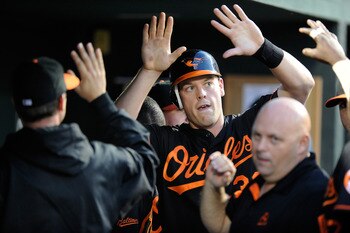 BALTIMORE, MD - MAY 20:  Matt Wieters #32 of the Baltimore Orioles celebrates with teammates after scoring in the third inning against the Washington Nationals at Oriole Park at Camden Yards on May 20, 2011 in Baltimore, Maryland.  (Photo by Greg Fiume/Ge