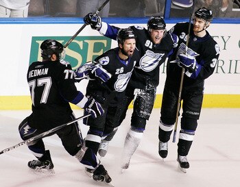 TAMPA, FL - MAY 25:  Martin St. Louis #26 of the Tampa Bay Lightning celebrates his second period goal with teammates in Game Six of the Eastern Conference Finals against the Boston Bruins during the 2011 NHL Stanley Cup Playoffs at St Pete Times Forum on