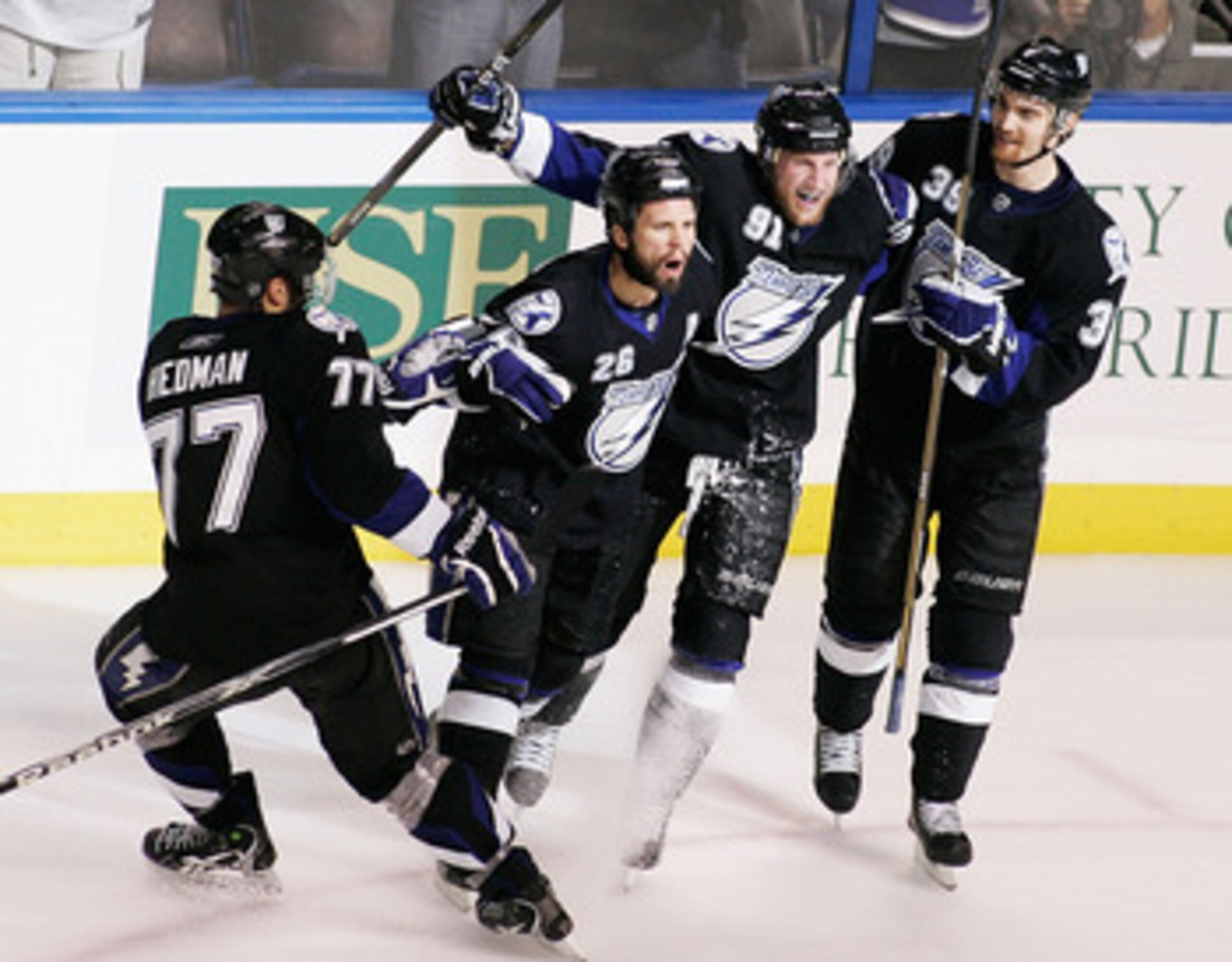 TAMPA, FL - MAY 25:  Martin St. Louis #26 of the Tampa Bay Lightning celebrates his second period goal with teammates in Game Six of the Eastern Conference Finals against the Boston Bruins during the 2011 NHL Stanley Cup Playoffs at St Pete Times Forum on