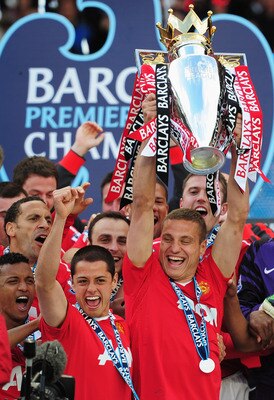 MANCHESTER, ENGLAND - MAY 22:  Captain Nemanja Vidic of Manchester United lifts the Premier League trophy alongside Javier Hernandez after the Barclays Premier League match between Manchester United and Blackpool at Old Trafford on May 22, 2011 in Manches