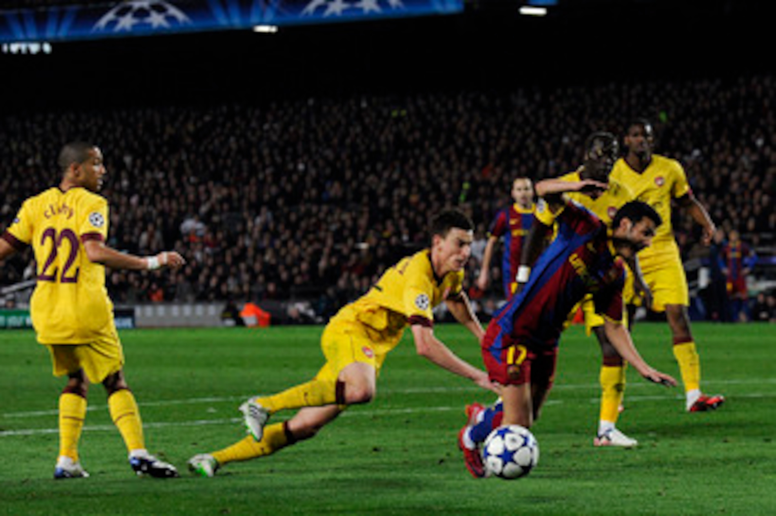 BARCELONA, SPAIN - MARCH 08:  Laurent Koscielny of Arsenal brings down Pedro Rodriguez of FC Barcelona to concede a penalty during the UEFA Champions League round of 16 second leg match between Barcelona and Arsenal at the Camp Nou stadium on March 8, 201