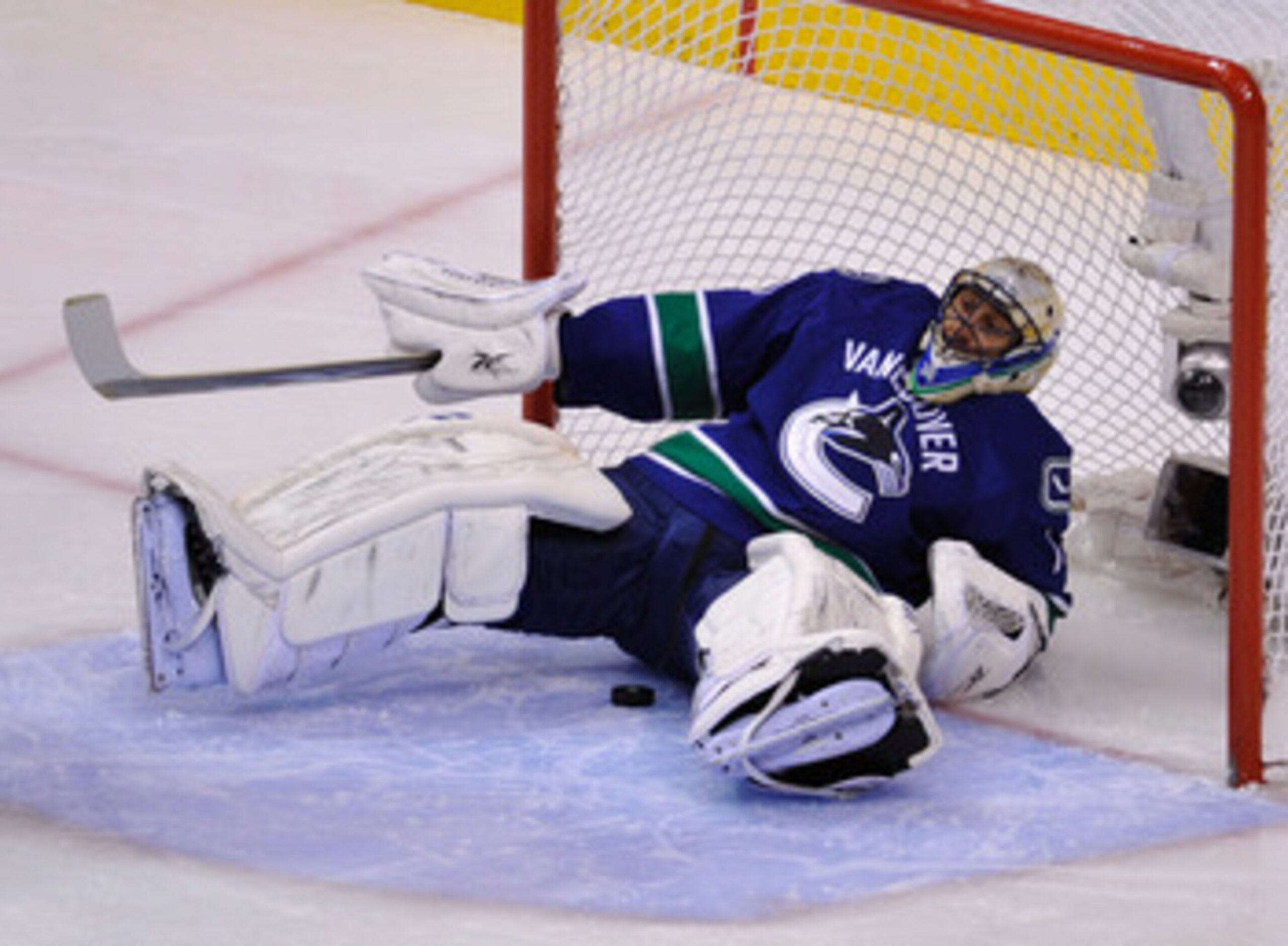 VANCOUVER, CANADA - MAY 24:  Goaltender Roberto Luongo #1 of the Vancouver Canucks falls back into the net after making a save in the first period in Game Five of the Western Conference Finals against the San Jose Sharks during the 2011 Stanley Cup Playof