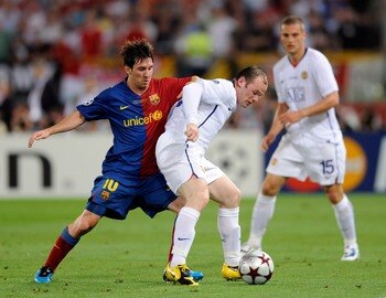ROME, ITALY - MAY 27:  Wayne Rooney (R) of Manchester United FC is challenged by Lionel Messi of Barcelona during the UEFA Champions League Final match between Barcelona and Manchester United at the Stadio Olimpico on May 27, 2009 in Rome, Italy.  (Photo
