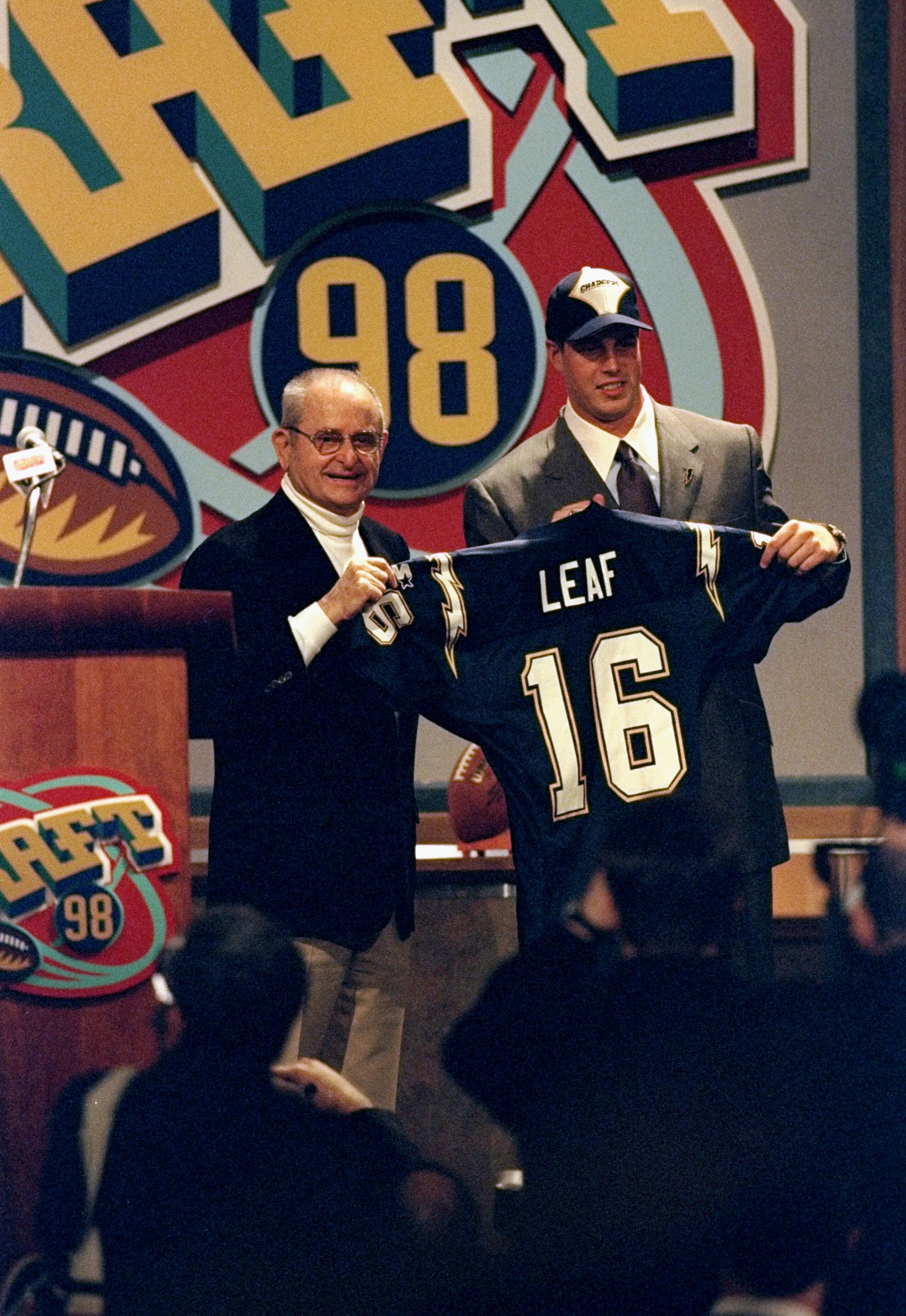 18 Apr 1998:  Second overall pick Ryan Leaf shows off his jersey alongside Alex Spanos after being selected by the San Diego Chargers in the first round of the 1998 NFL Draft at Madison Square Garden in Manhattan, New York. Mandatory Credit: Jamie Squire