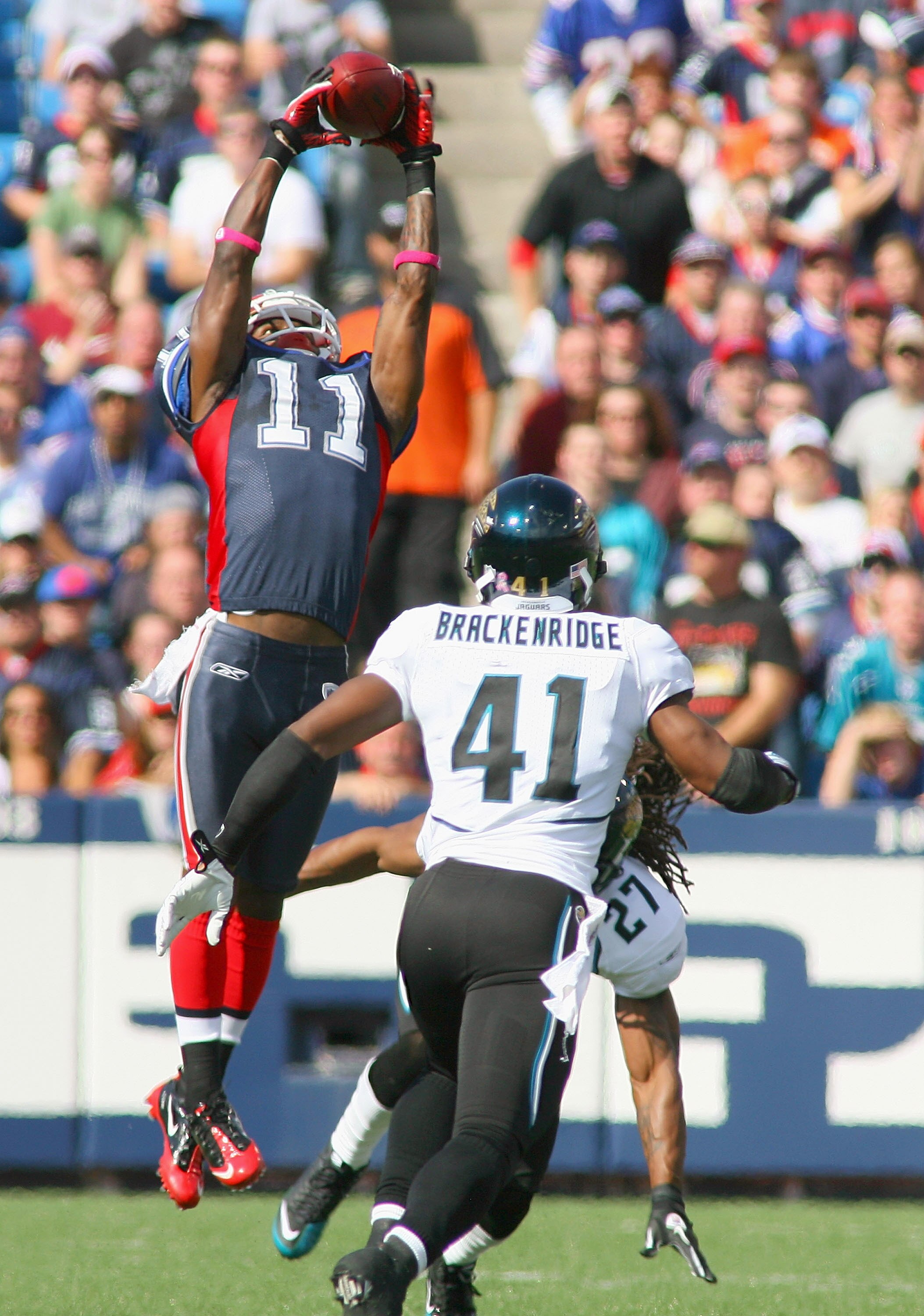 ORCHARD PARK, NY - OCTOBER 10: Roscoe Parrish #11 of the Buffalo Bills makes a catch above Rashean Mathis #27 and Tyron Brackenridge #41 of  the Jacksonville Jaguars at Ralph Wilson Stadium on October 10, 2010 in Orchard Park, New York.  (Photo by Rick St