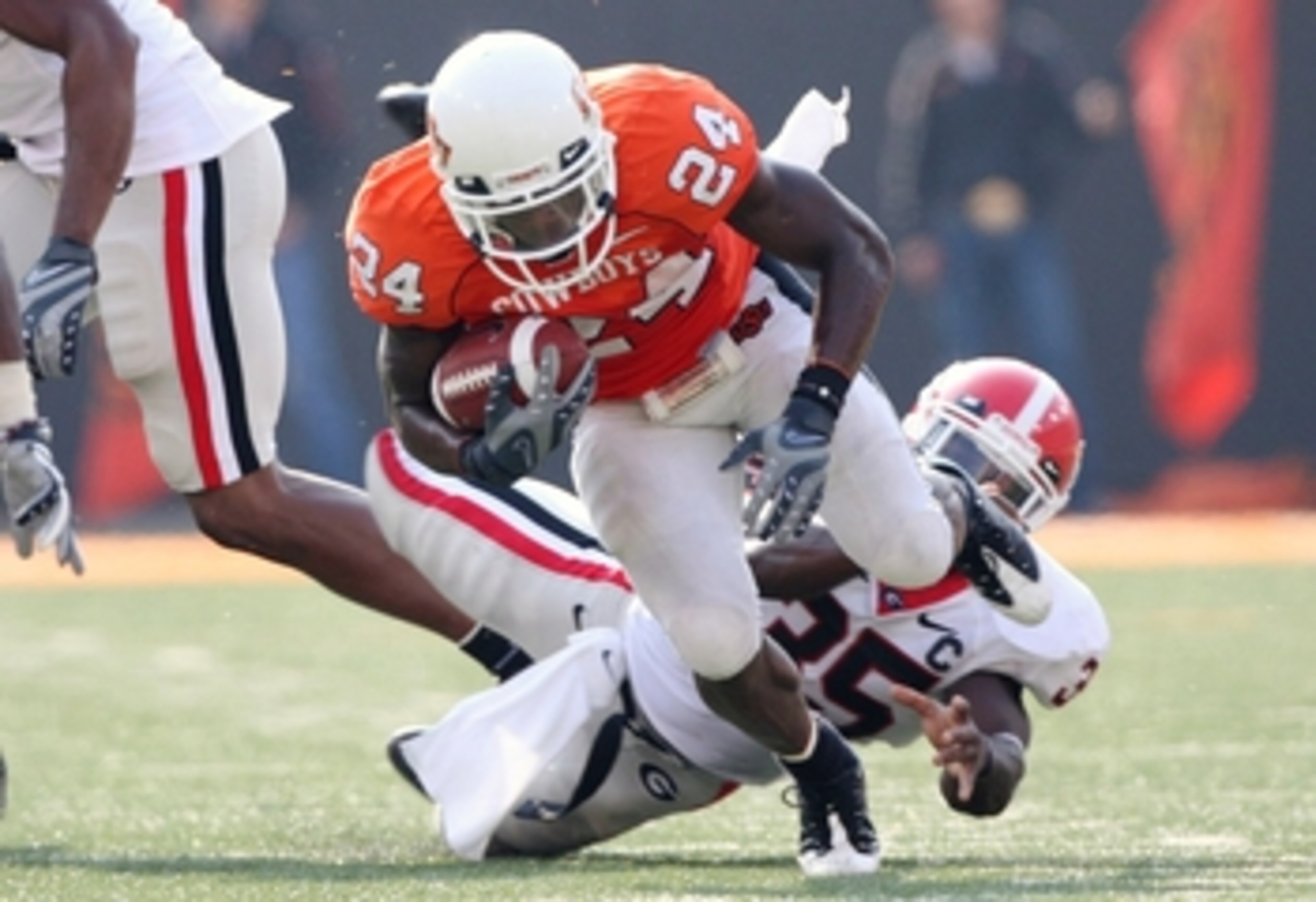 STILLWATER, OK - SEPTEMBER 5: Running back Kendall Hunter #24 of the Oklahoma State Cowboys carries the ball six yards as Rennie Curran #35 of the Georgia Bulldogs tries to stop him during the fourth quarter of the game at Boone Pickens Stadium on Septemb