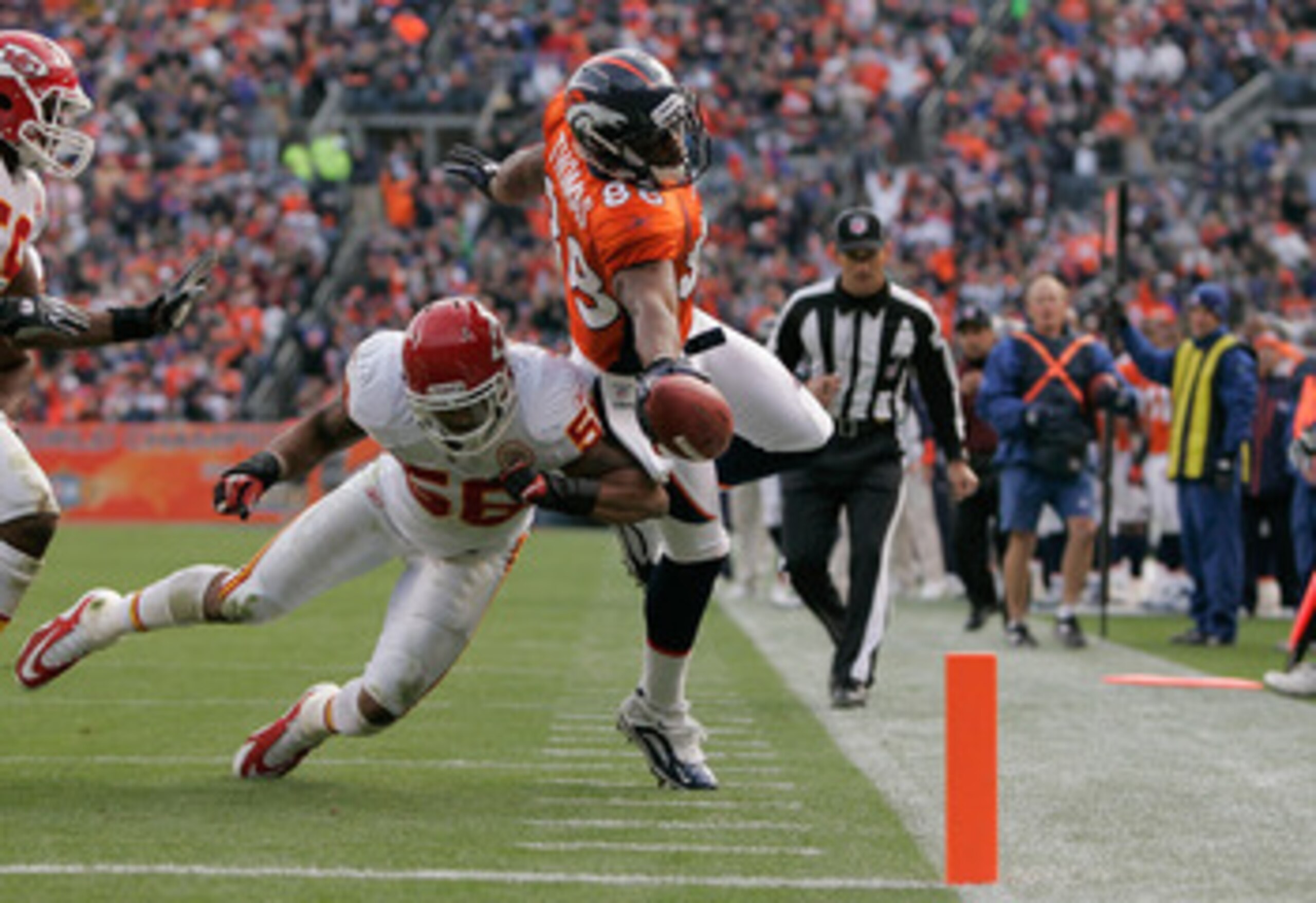 DENVER - NOVEMBER 14:  Wide receiver Demaryius Thomas #88 of the Denver Broncos stretches the ball towards the goal line but is knocked out of bounds by linebacker Derrick Johnson #56 of the Kansas City Chiefs at the 1-yard-line during the second quarter 