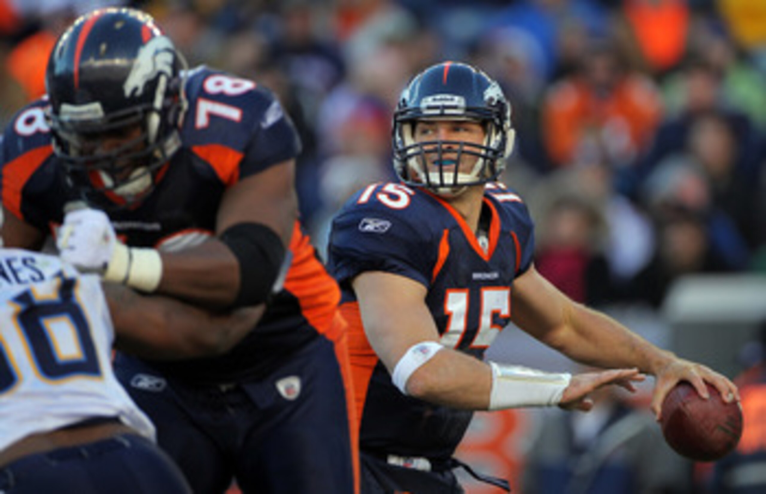 DENVER - JANUARY 02: Quarterback Tim Tebow #15 of the Denver Broncos looks to deliver a pass behind the protection of offensive lineman Ryan Clady #78 as he blocks Antwan Barnes #98 of the San Diego Chargers at INVESCO Field at Mile High on January 2, 20 DENVER - JANUARY 02: Quarterback Tim Tebow #15 of the Denver Broncos looks to deliver a pass behind the protection of offensive lineman Ryan Clady #78 as he blocks Antwan Barnes #98 of the San Diego Chargers at INVESCO Field at Mile High on January 2, 20